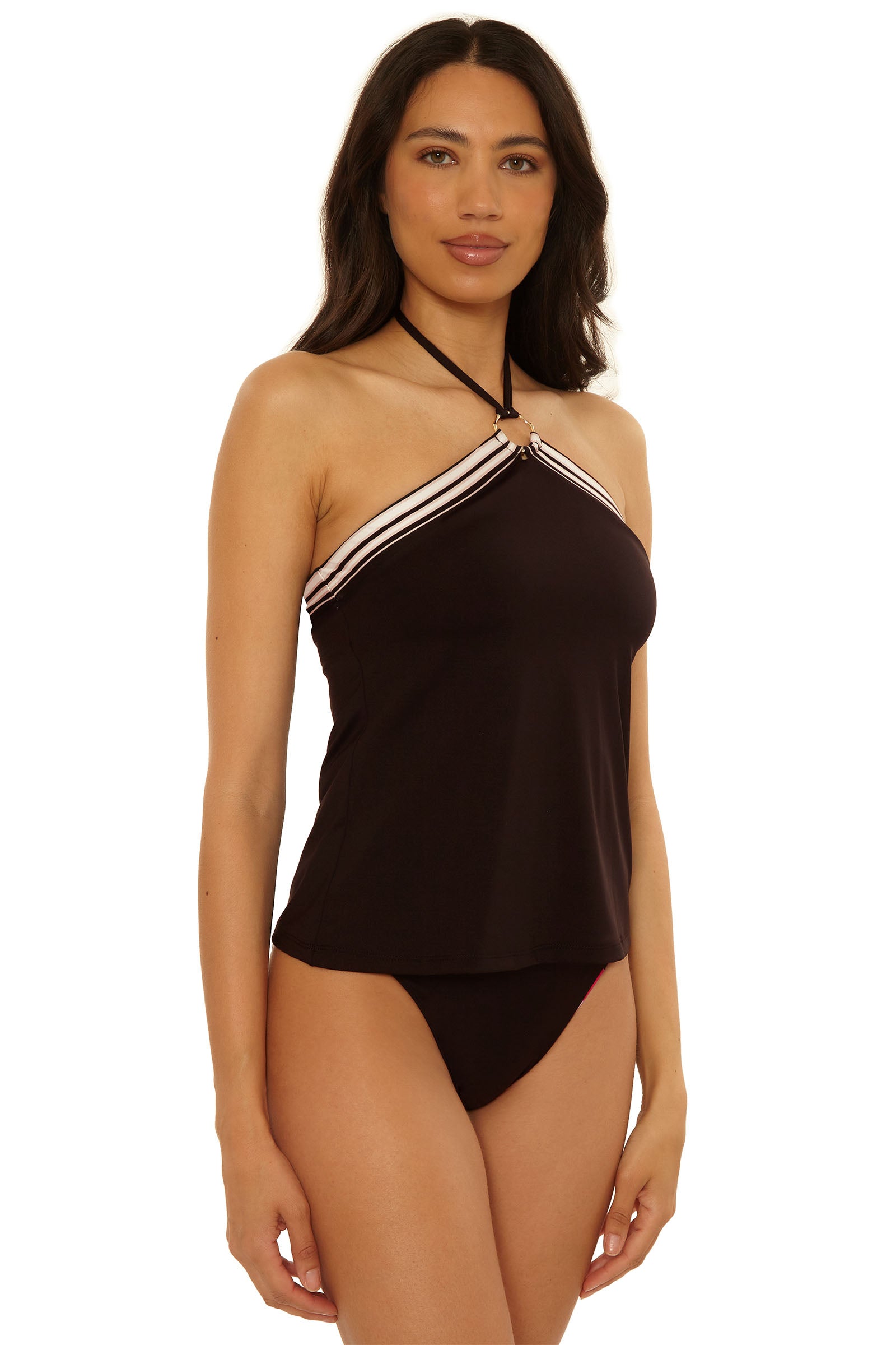 A woman wearing the Reversible Tankini Swim Top - Bougainvillea with matching black bikini bottoms, standing against a plain white background.