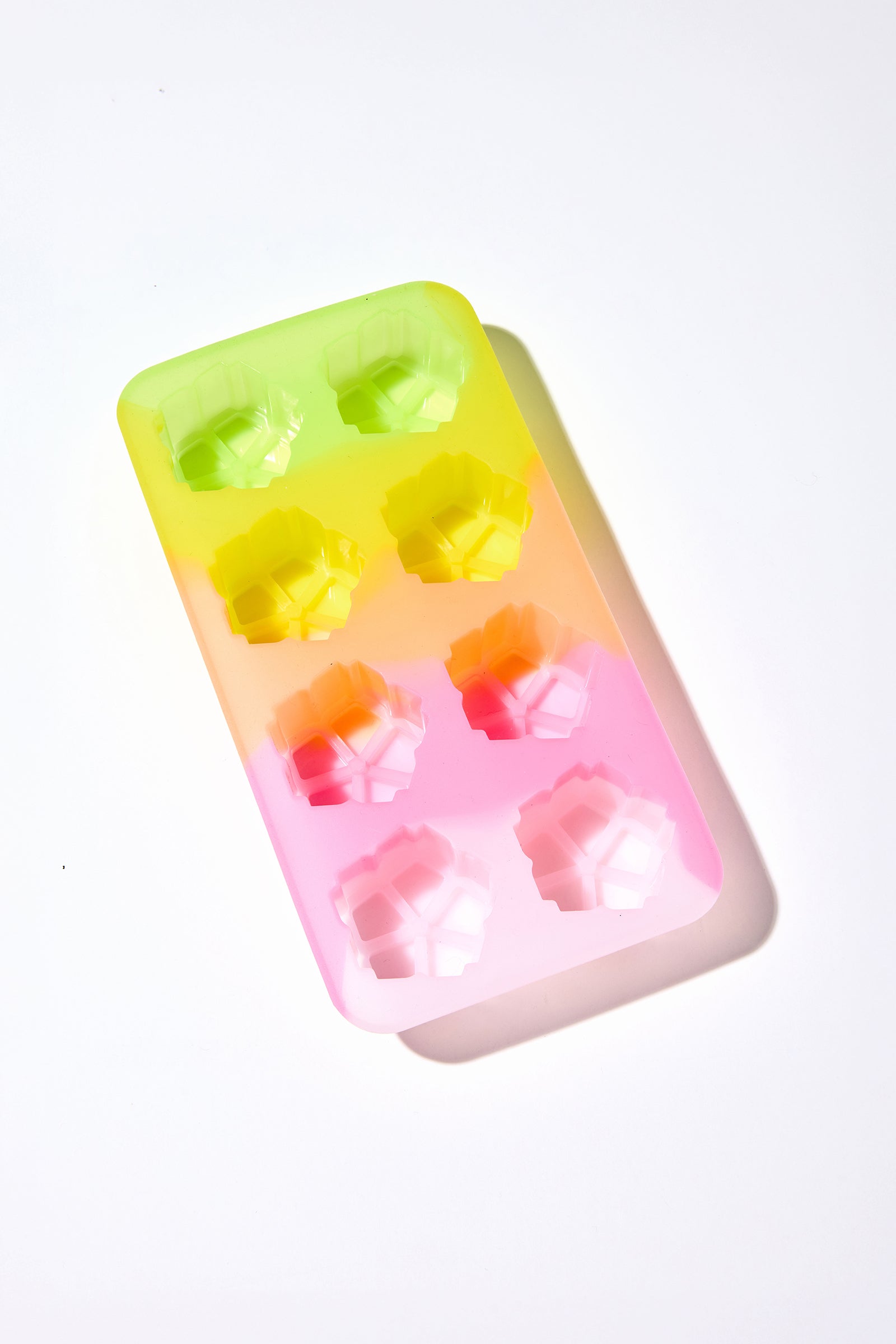 A Cocktail Glass Set with a silicone floret mold—featuring eight gem-shaped cavities in a green, yellow, and pink gradient—is displayed on a white background.