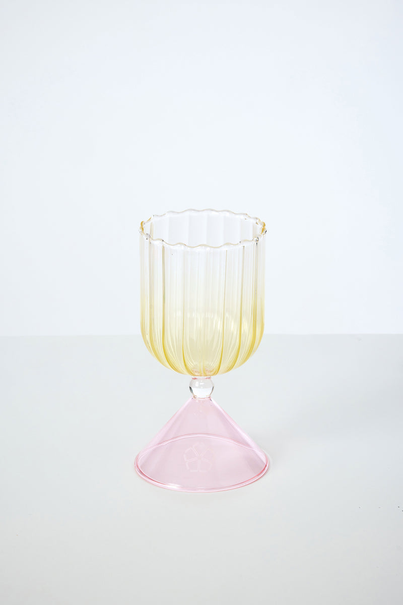 A Cocktail Glass from the set with Silicone Floret Mold, featuring a fluted yellow-tinted bowl and wide pink base, sits on a plain white surface against a light background.