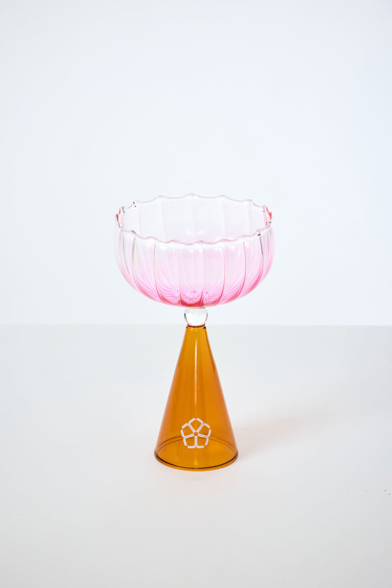 A Cocktail Glass with a fluted pink bowl and cone-shaped amber base, from the Cocktail Glass Set with Silicone Floret Mold, displayed against a plain white background.