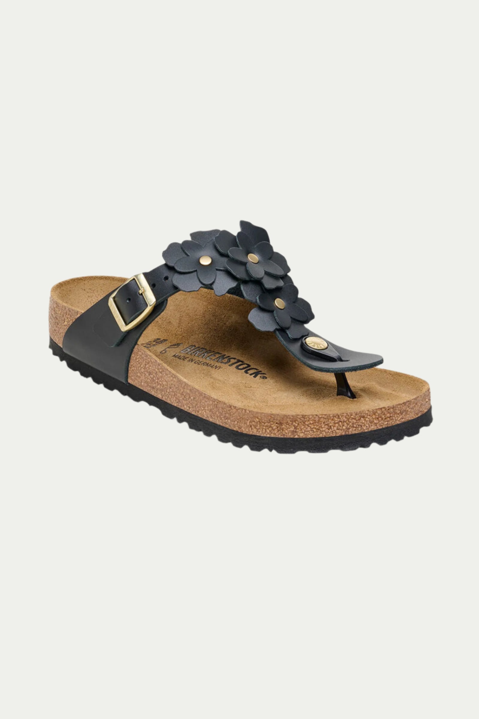 The Womens Gizeh Flowers Leather Sandal in black features floral accents, a side buckle closure, and a cork footbed with a textured rubber sole.