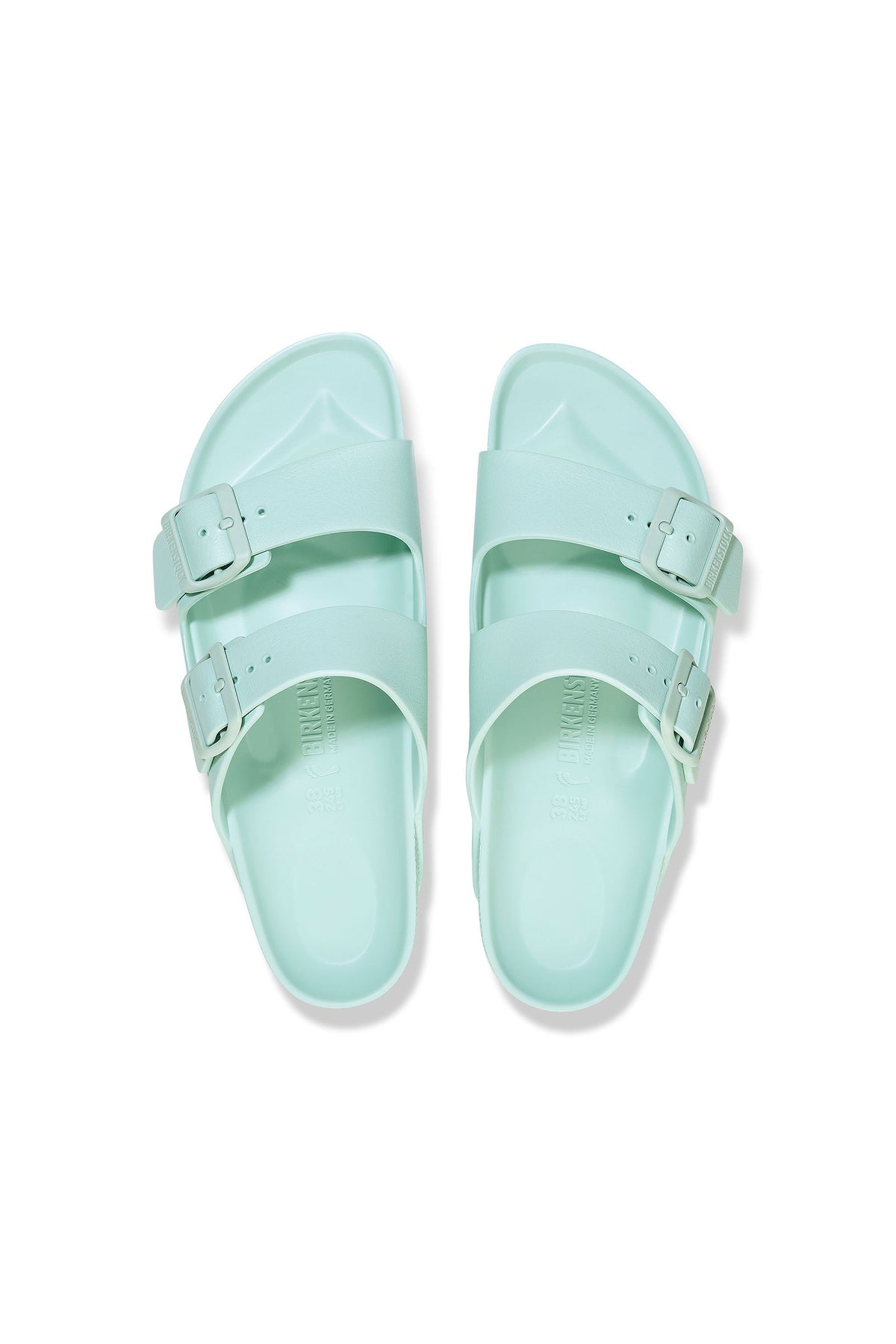 The Mens Arizona Green Eva Slide Sandal features a light mint green color, two adjustable buckle straps per sandal, and a lightweight EVA construction, shown side by side on a white background.