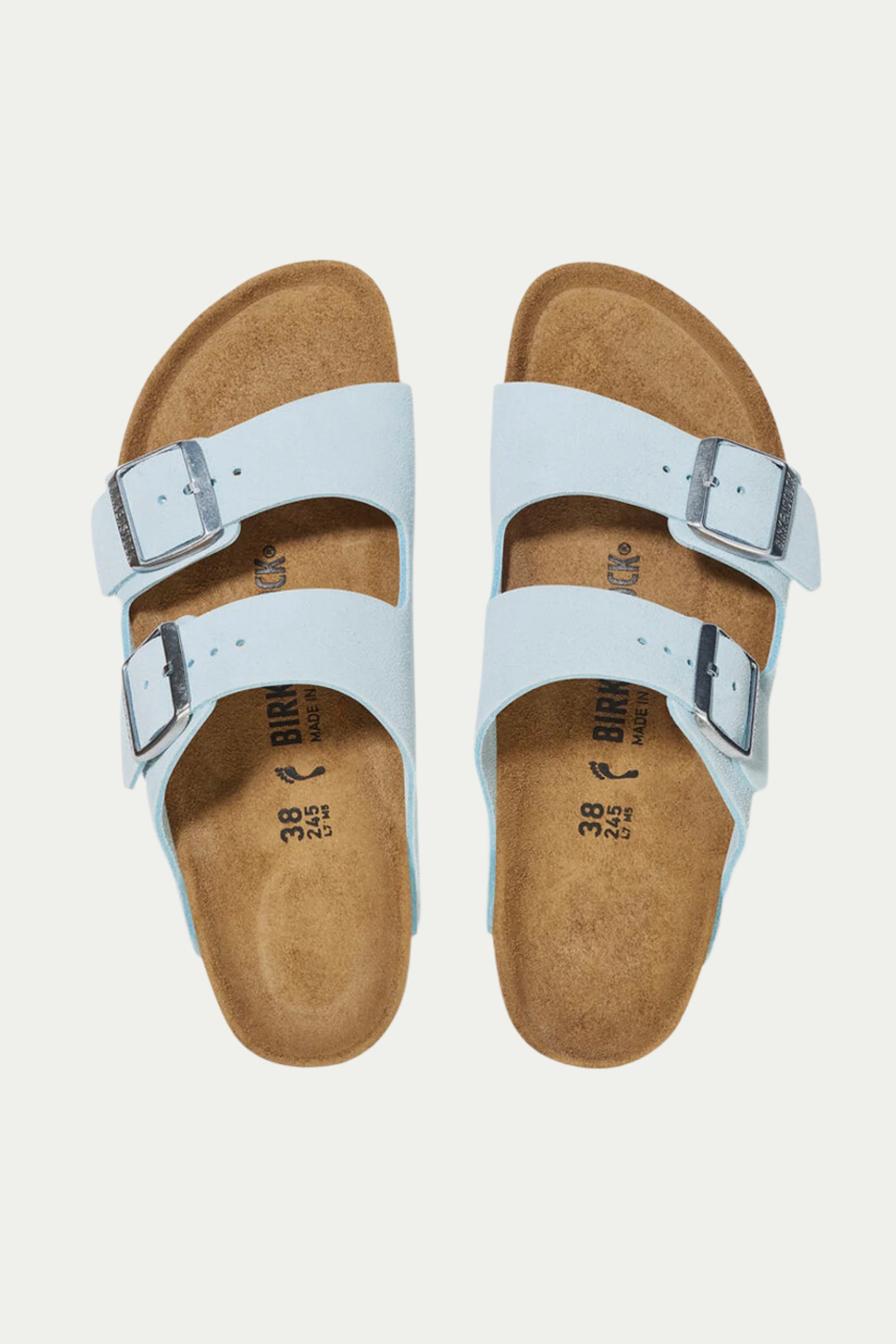 The Womens Arizona Suede Sandal, shown from above, features light blue suede with two adjustable buckle straps per sandal and brown contoured cork footbeds.