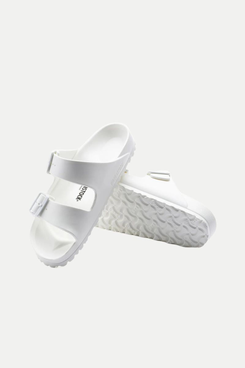 The Mens Arizona White Eva Slide Sandal features two buckle straps. Displayed on a white background, one sandal stands upright to reveal the textured sole, while the other lies flat.
