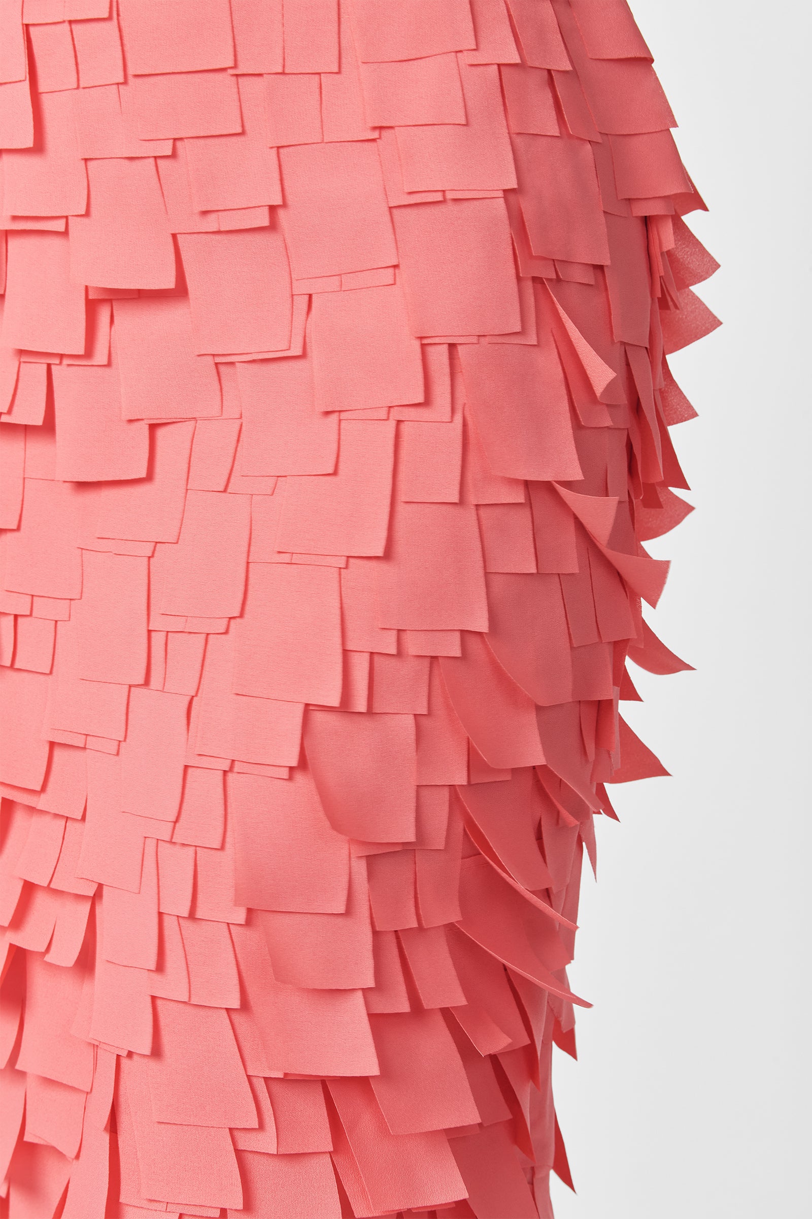 Close-up of the Dita Midi Pencil Skirt - Flutter Chiffon, featuring overlapping rectangular pink chiffon pieces that create a textured, layered effect against a plain white background.