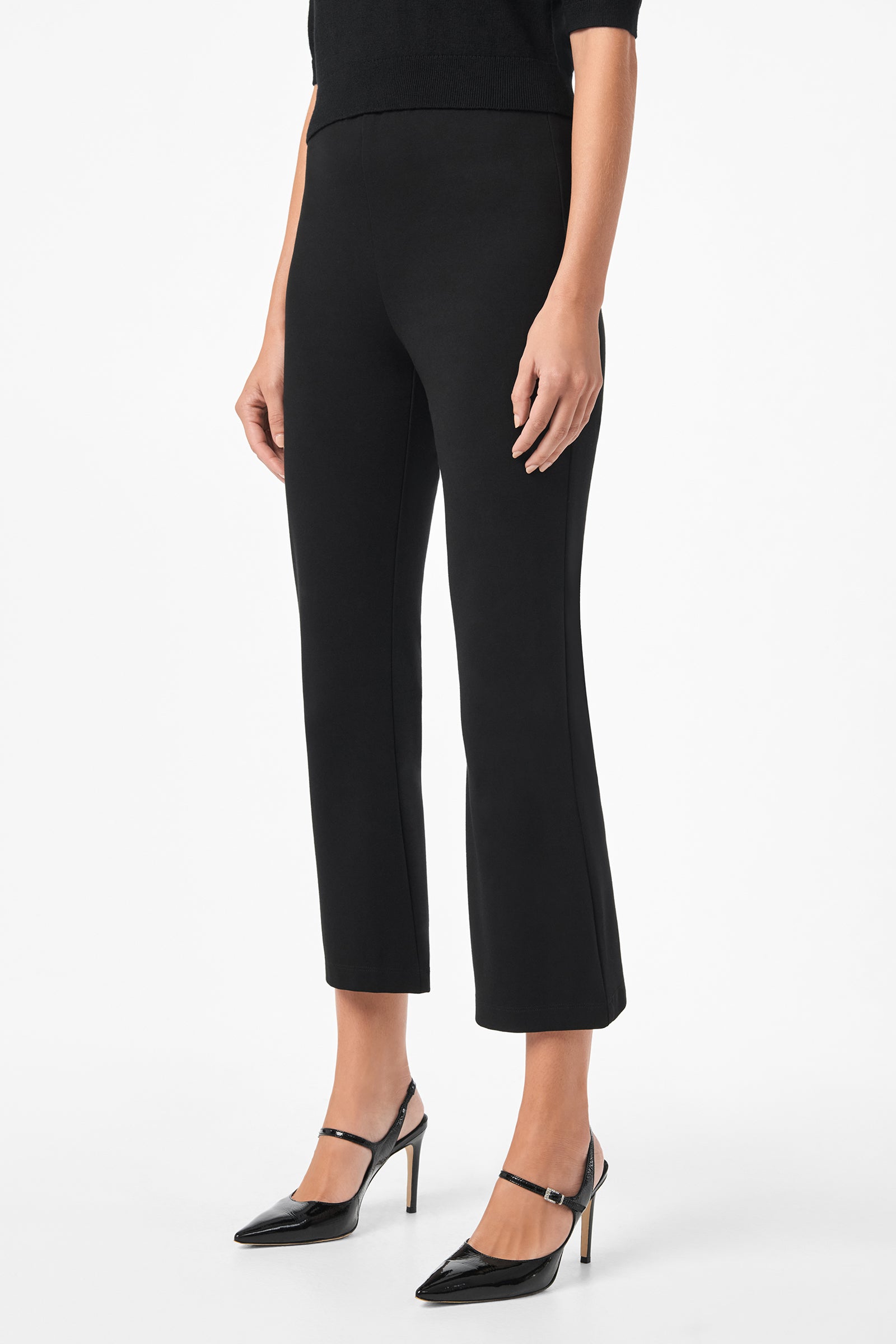 A person wears Sorrel Kick-Flare Pants—black, fitted, ankle-length—paired with black high heels, standing against a plain white background. The upper body is partially out of frame.