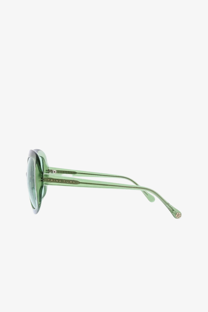 Side view of the Bedarra Sunglasses in green, featuring semi-transparent round frames and thin arms, set against a plain white background.