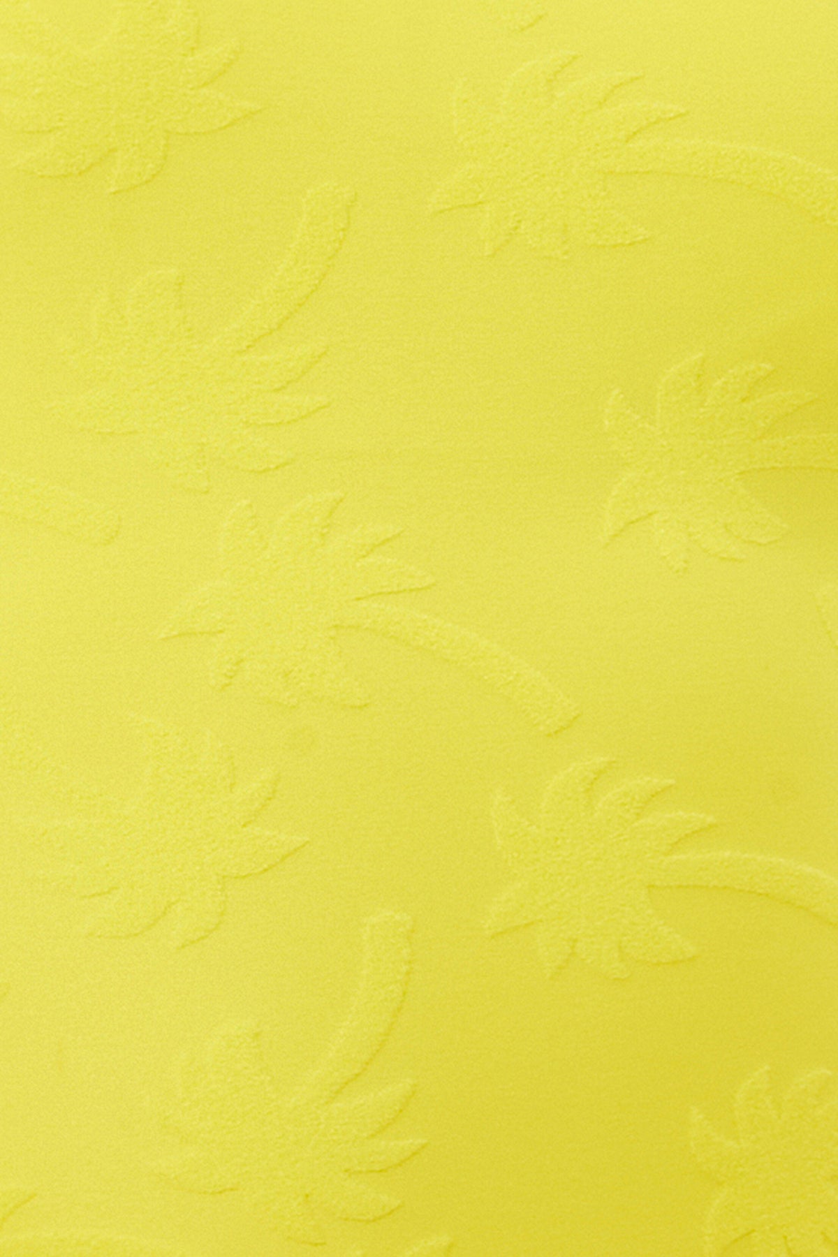 The Women's Sway Ruffle Plunge One Piece Swimsuit showcases a bright yellow surface with a subtle embossed palm tree pattern, adding textured, tropical flair.