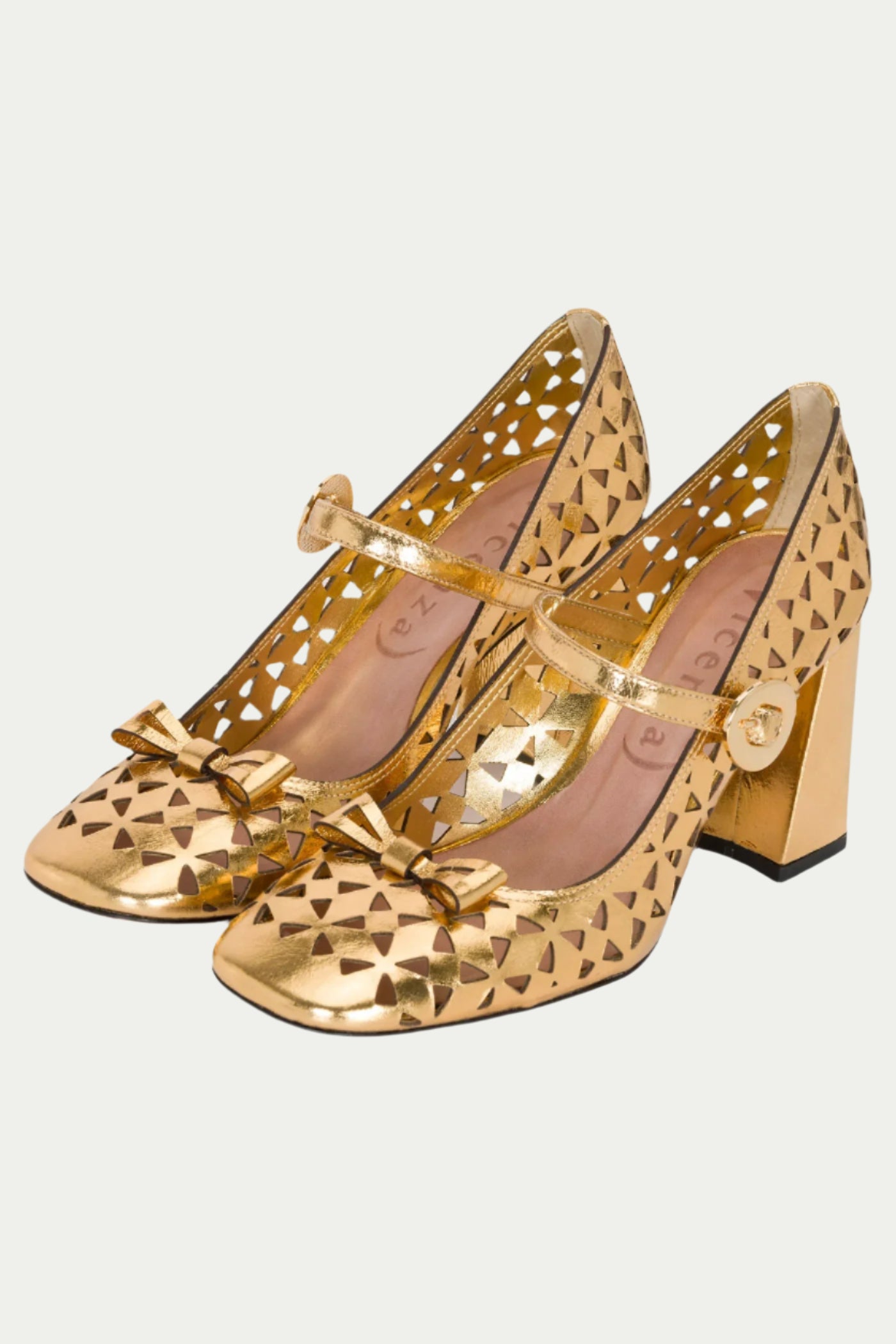 The Georgina Mary Jane Cutout Leather Heel in gold features a block heel, geometric cutouts, small toe bows, and ankle straps with buckle closures.