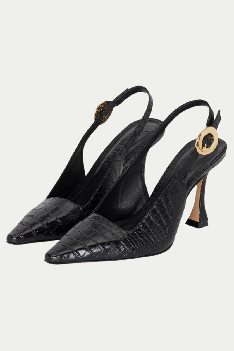 The Naomi Slingback Heel is a pair of black, crocodile-textured heels with pointed toes, sculpted heels, and gold circular buckles on the ankle straps.
