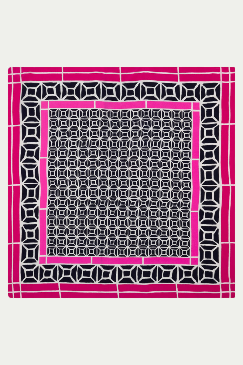 The Durell Scarf - Silk features a bold, symmetrical geometric pattern of interlocking black and white shapes, accented by magenta and white rectangular borders on a crisp white background.