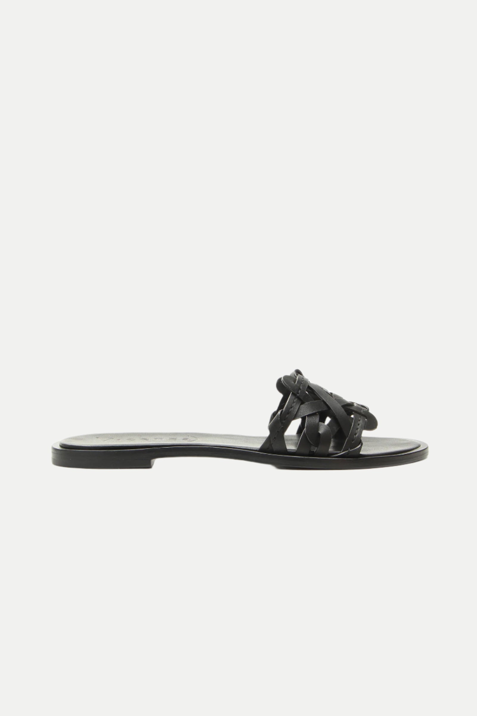 Haia Black Woven Leather Slide Sandal in black, featuring a woven leather upper and open toe, shown in profile view against a plain white background.