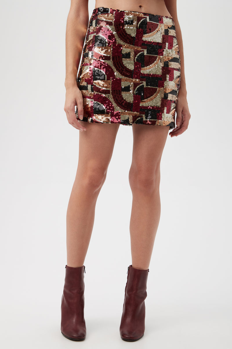 A person is wearing the Rico Galerie Arte Sequin Mini Skirt in multi, paired with burgundy ankle boots. The photo captures them from waist to feet.
