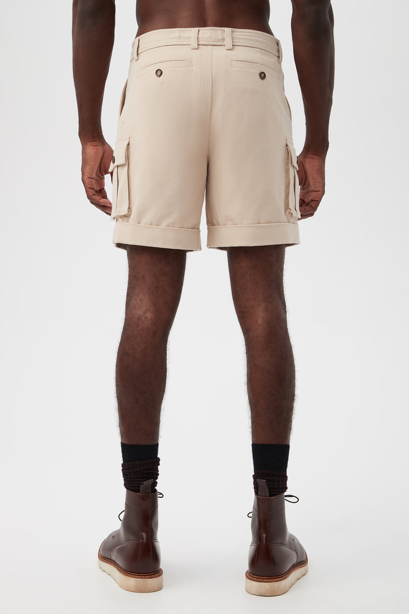 A person is seen from behind wearing the Westlake Cargo Short - Brushed Cotton Twill with dark socks and brown leather ankle boots, set against a plain white background.