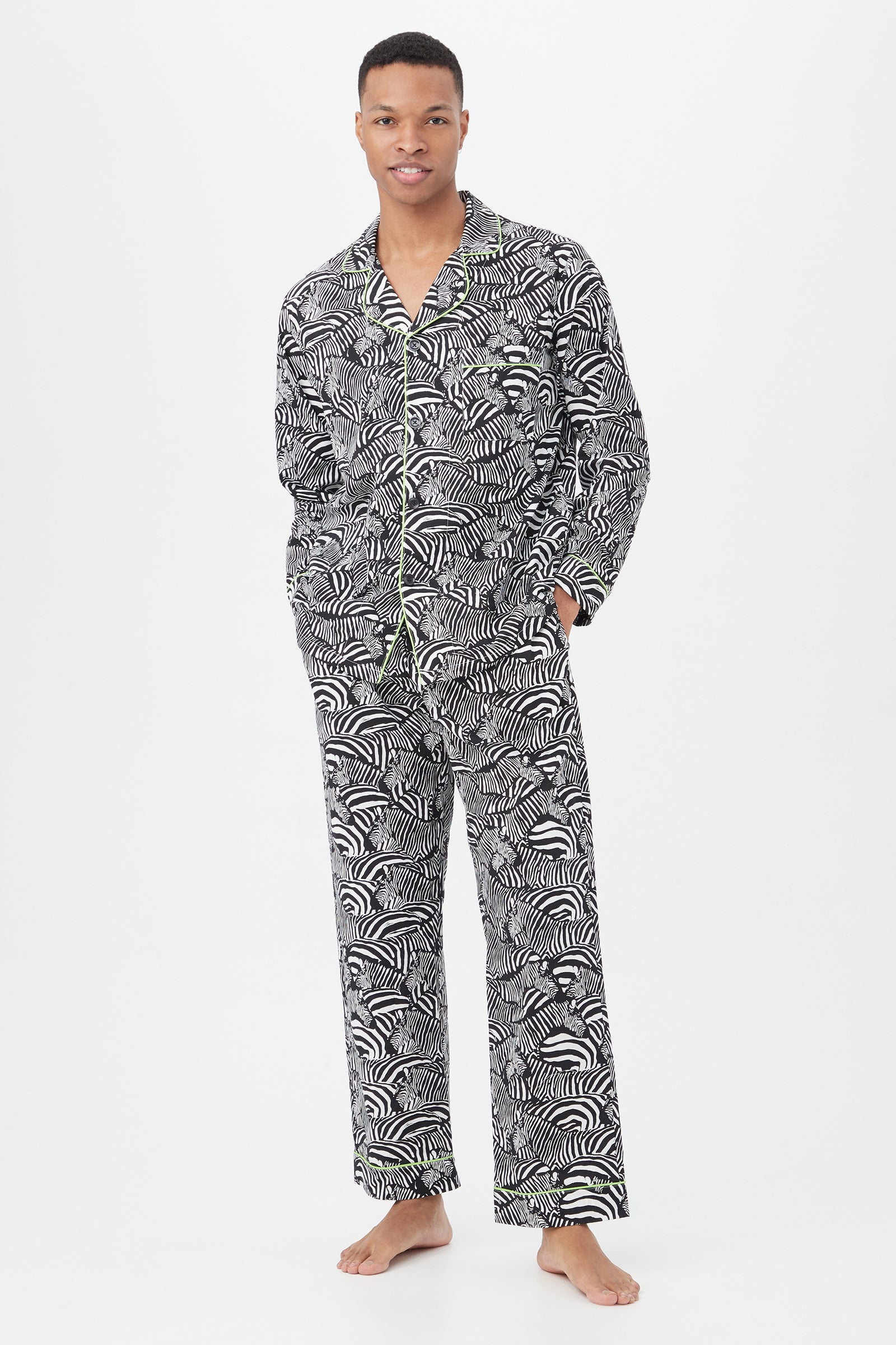 A person stands barefoot in the Zebra Safari Mens Long Sleeve Long Pant Poplin PJ Set in black/white, posing against a plain white background.