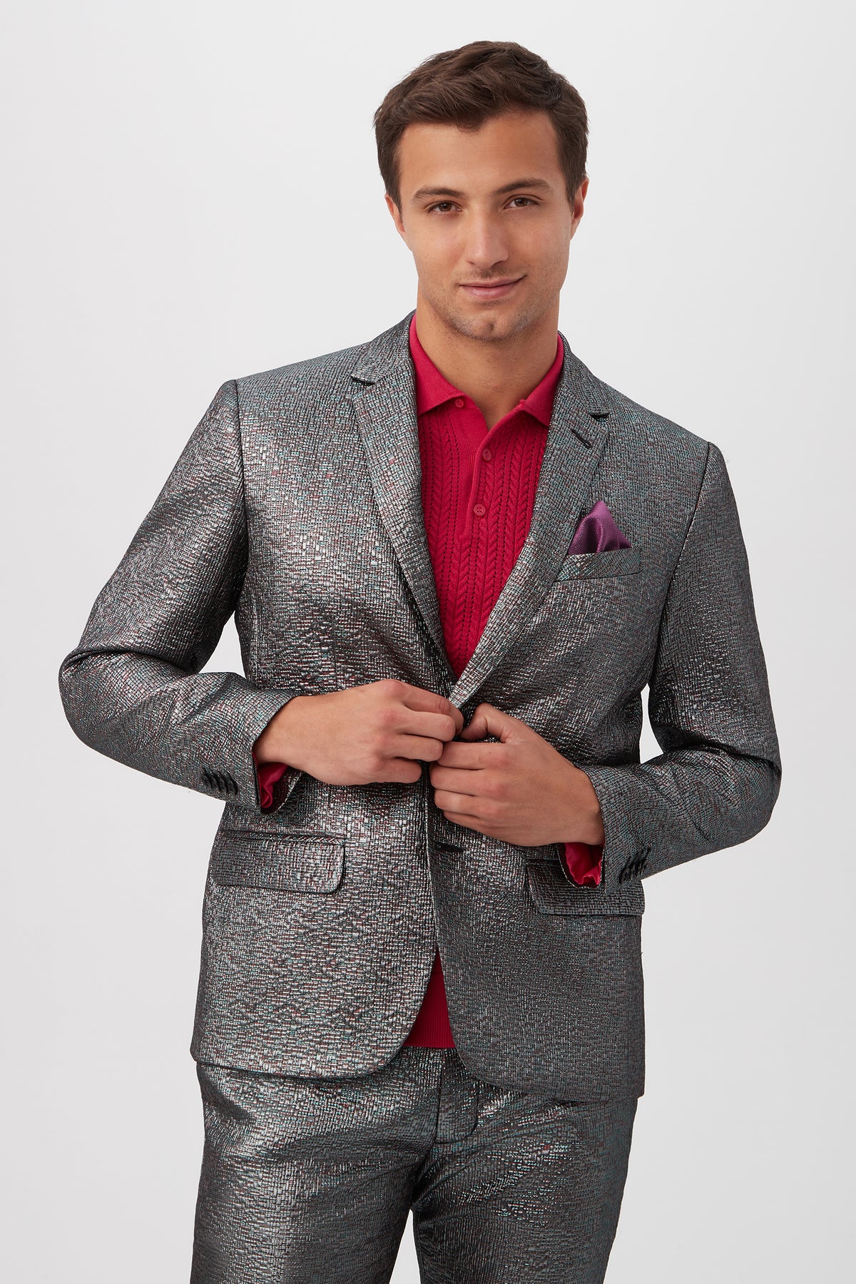 A man stands confidently against a white background, wearing the Thurston Blazer - Mini Stained Glass Jacquard (Multi) over a red shirt with a matching pocket square.