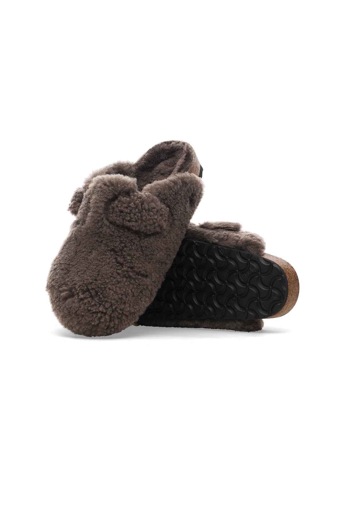 A pair of Womens Boston Big Buckle Teddy Grey Birkenstock clogs; one is upright, highlighting the soft teddy texture and buckle, while the other is on its side, revealing the black textured sole.