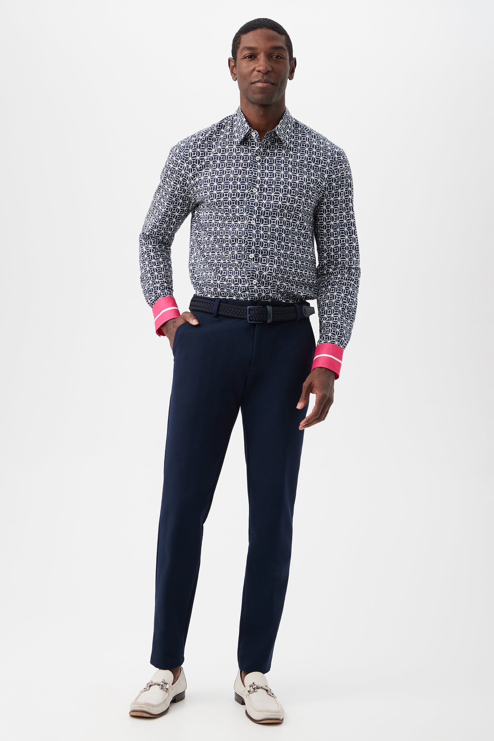 A man stands facing forward against a plain white background, wearing the Aaron 2 Slim Long-Sleeve Shirt with navy trousers, a dark belt, and white dress shoes.