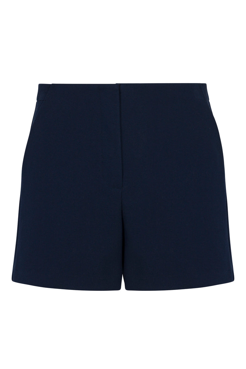 Valera Shorts - Stretch Piqué: Navy blue tailored shorts with a flat front, side pockets, and a clean, minimalist design, shown against a white background.