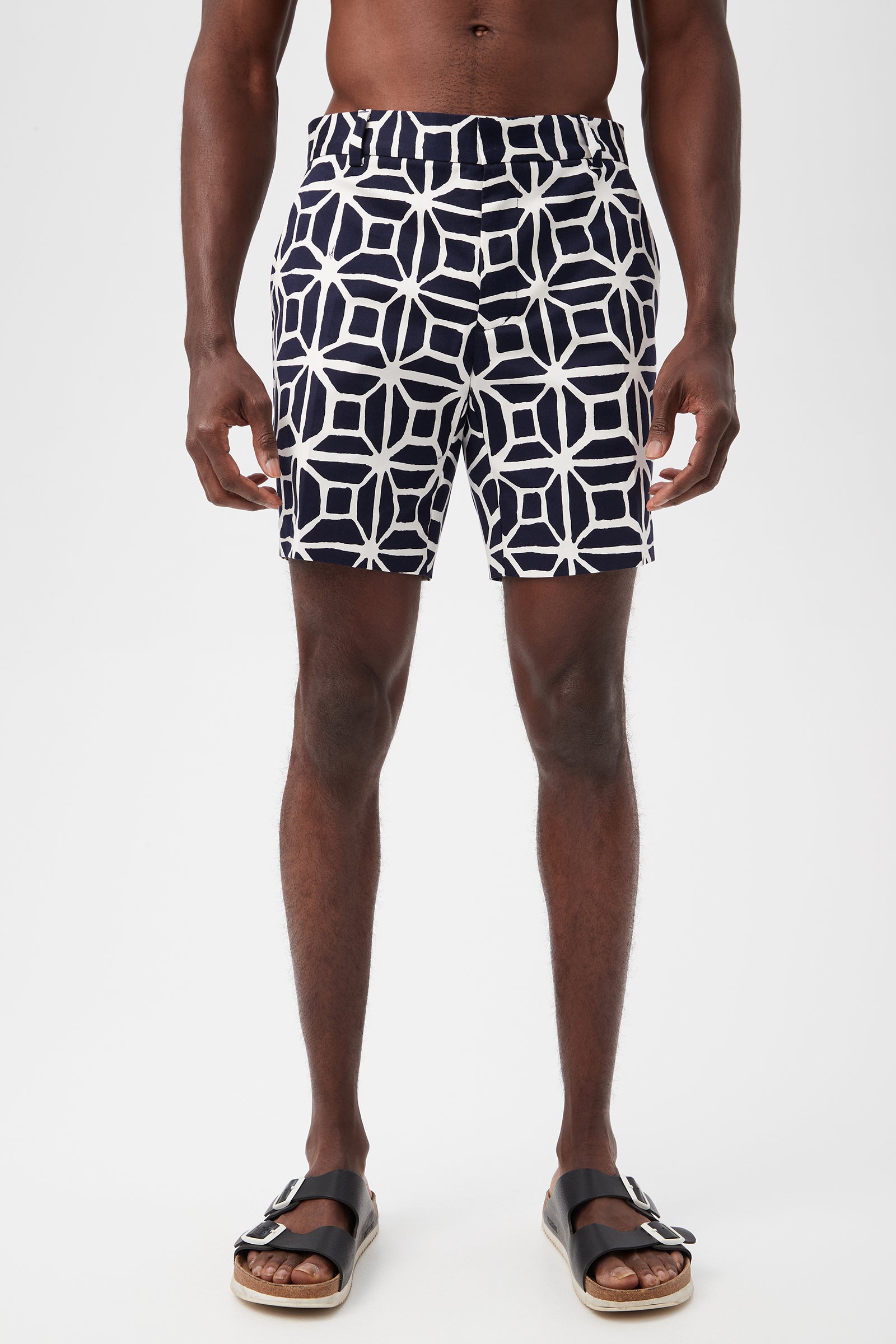 A person wearing the Lawrence Short - Durell Herringbone in indigo stands against a plain white background, shown from mid-torso to feet.