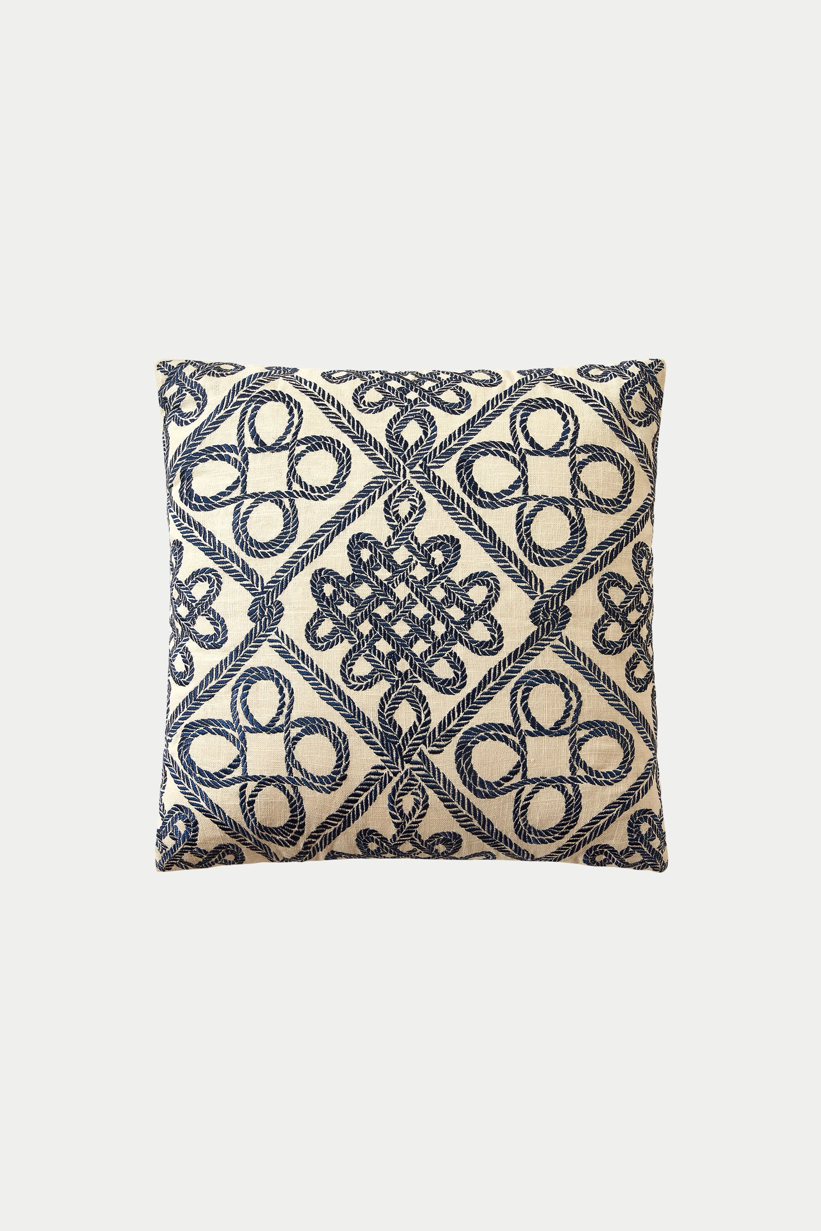 The Costa Mesa Embroidered Euro Throw Pillow - Blue features a cream background with intricate navy blue embroidered geometric and loop patterns arranged in a diamond grid.