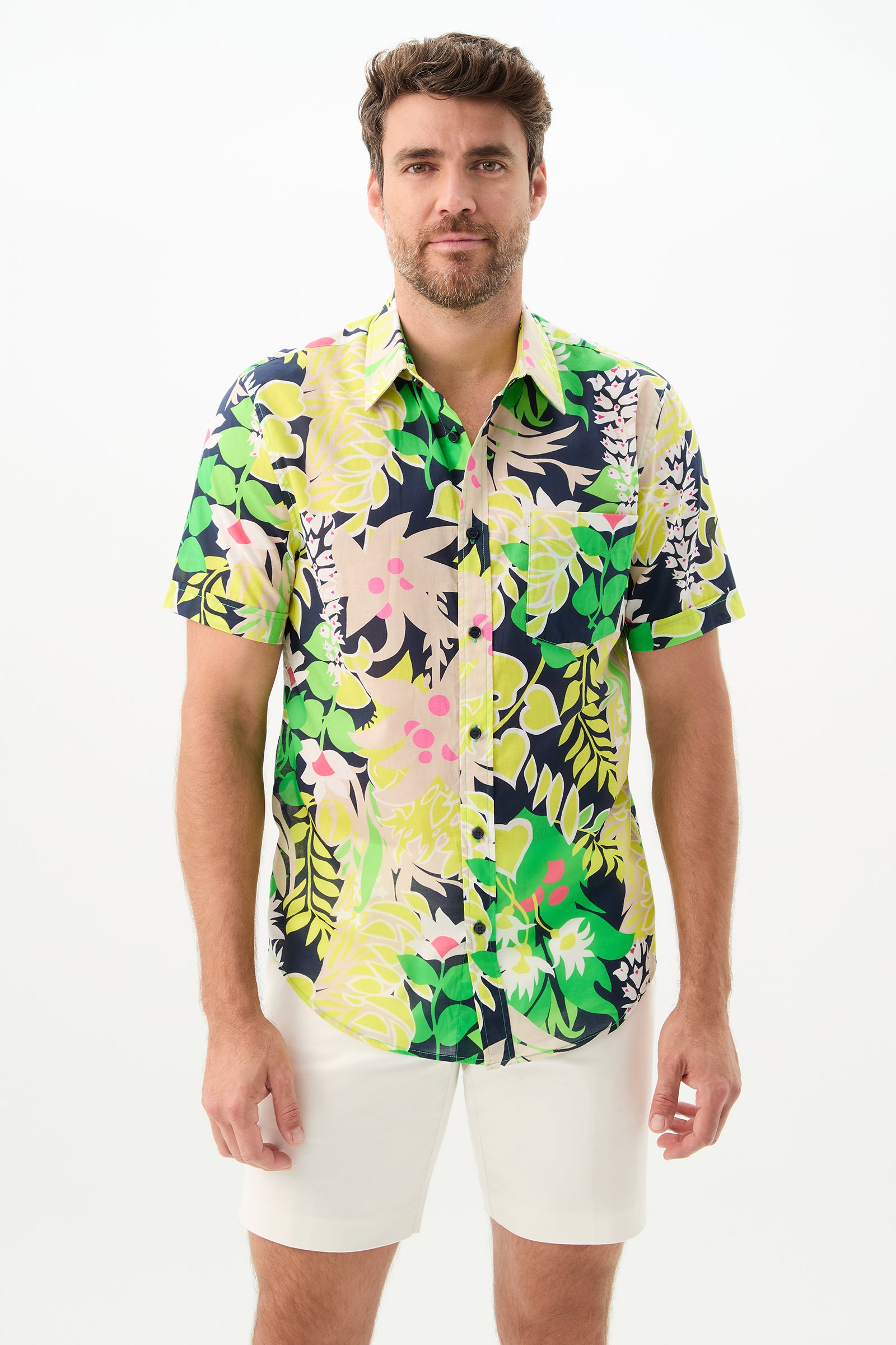 A man with brown hair and a beard wears the Slim Jim Short-Sleeve Shirt in Palm Springs Eternal and white shorts, standing facing the camera against a plain white background.
