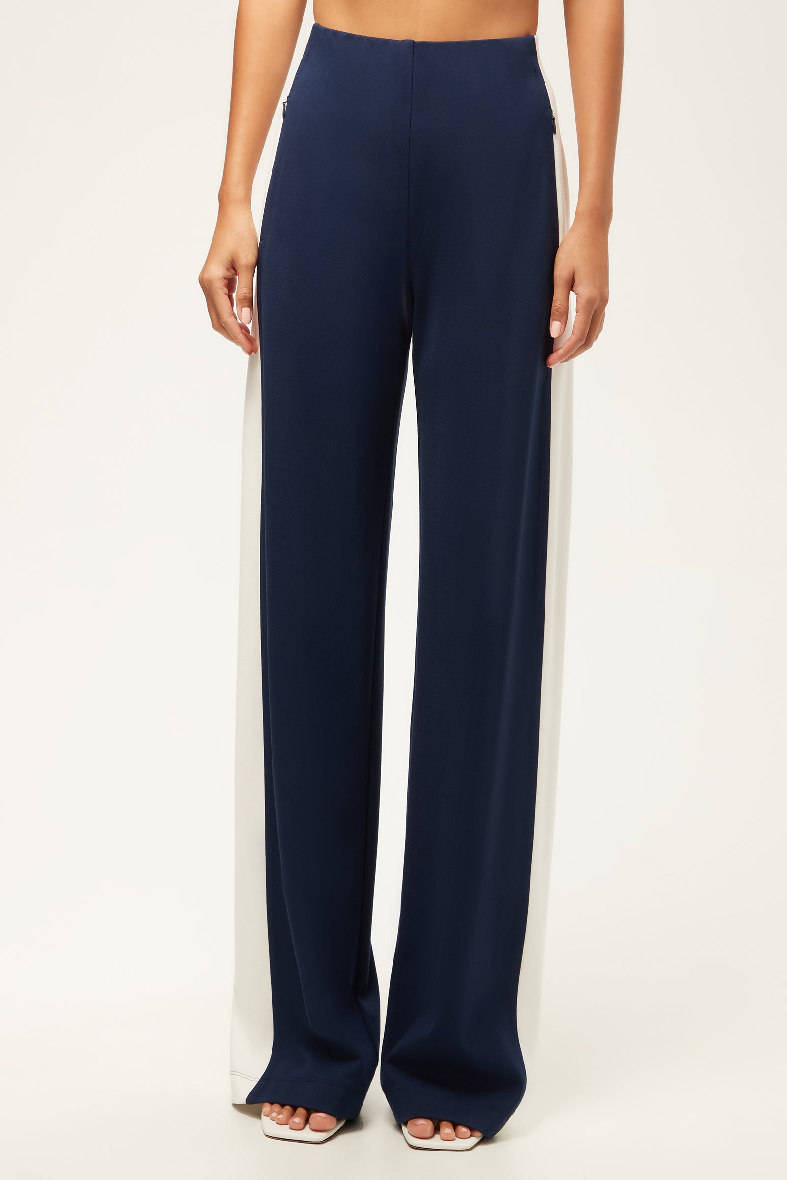 A person wearing the Record Wide-Leg Pant - Cozy Ponte in Ink/Whitewash, standing barefoot against a plain white background.