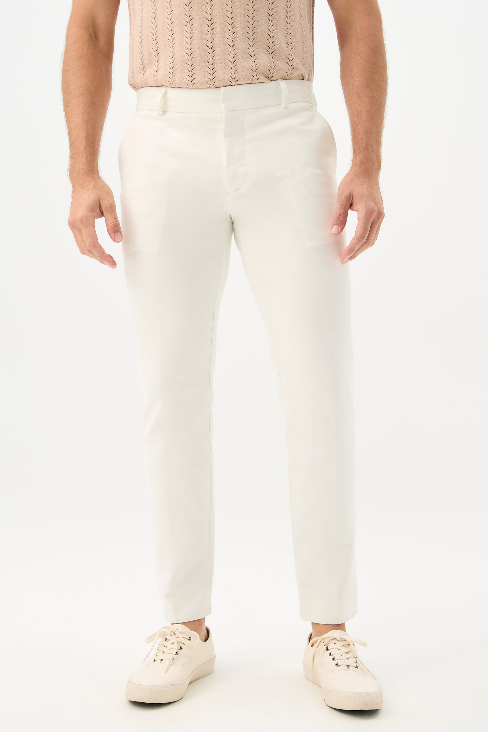 Wearing Clyde Slim Trouser - Solid Suiting in Whitewash, a person stands against a plain white background. Only the lower half of the body is visible.