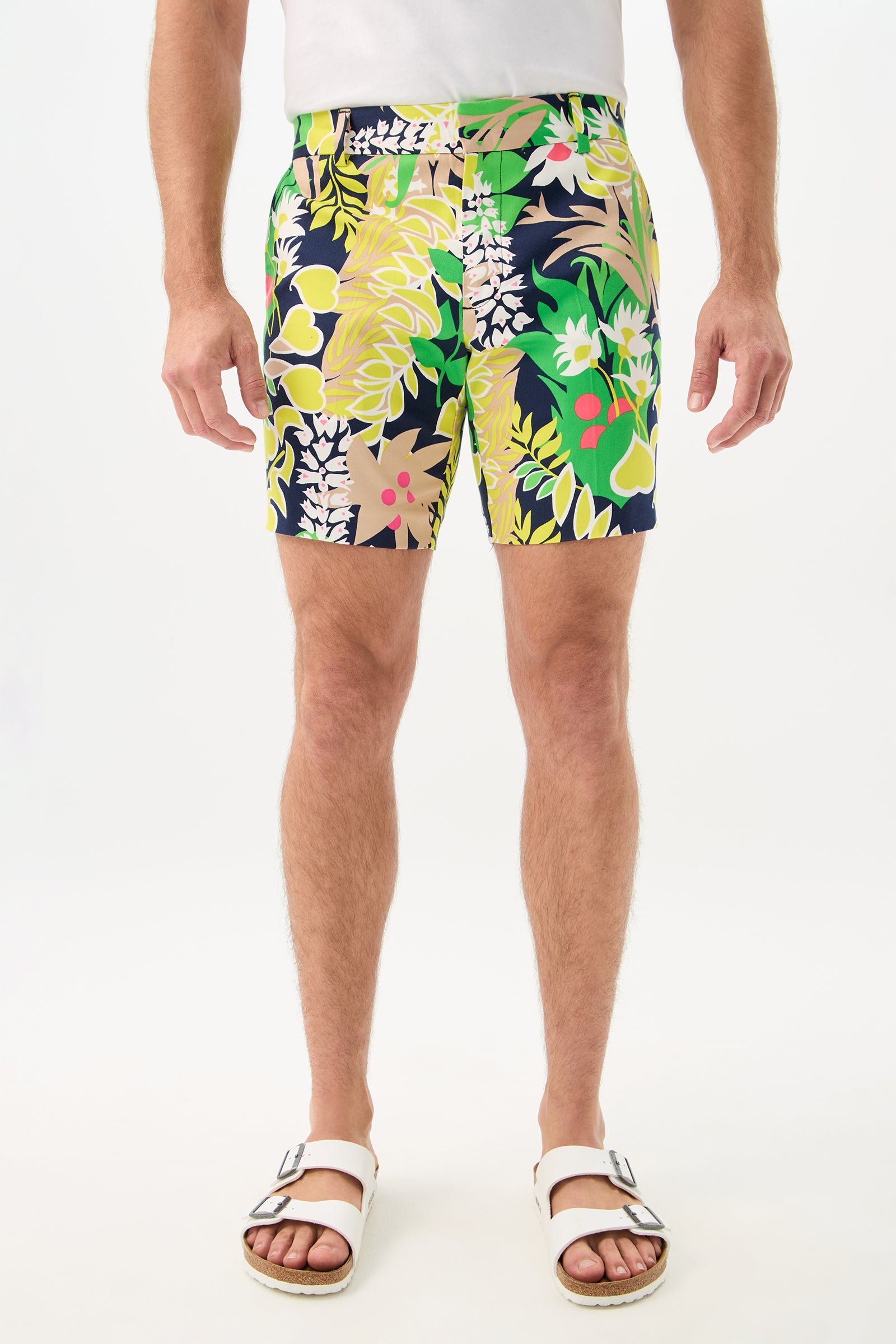 A person wearing the Lawrence Short - PS Eternal in Palm Springs Eternal, paired with a plain white t-shirt and white sandals, stands against a white background. The image is cropped above the shoulders.