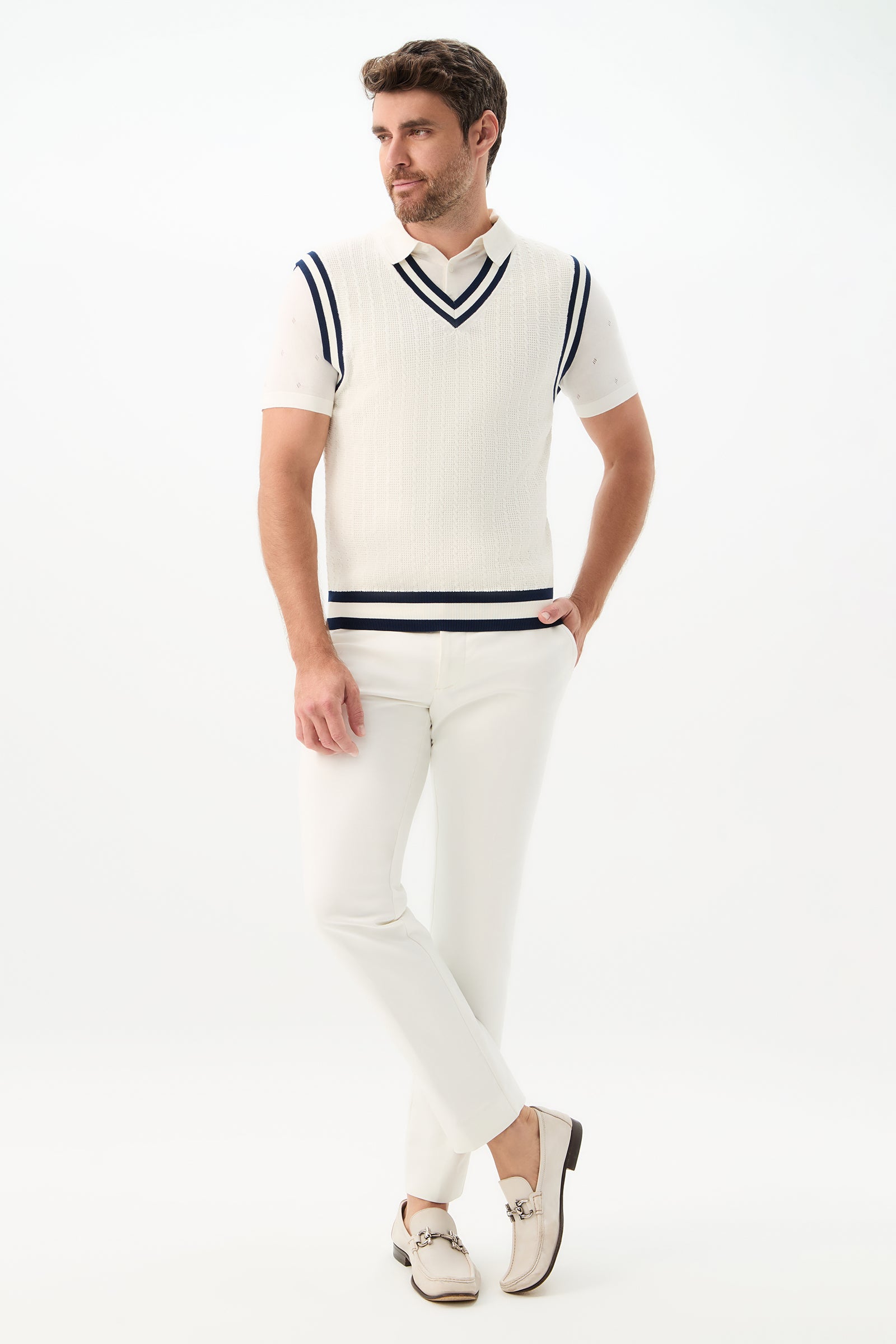 A man wearing the Matthew V-Neck Knit Vest styled with white pants.