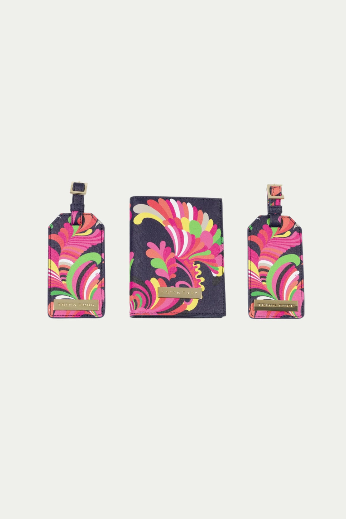 The Passport Tag Set - Palms Paradise includes a multi-colored passport holder and two luggage tags with abstract swirl patterns on a dark background, each featuring a gold nameplate.