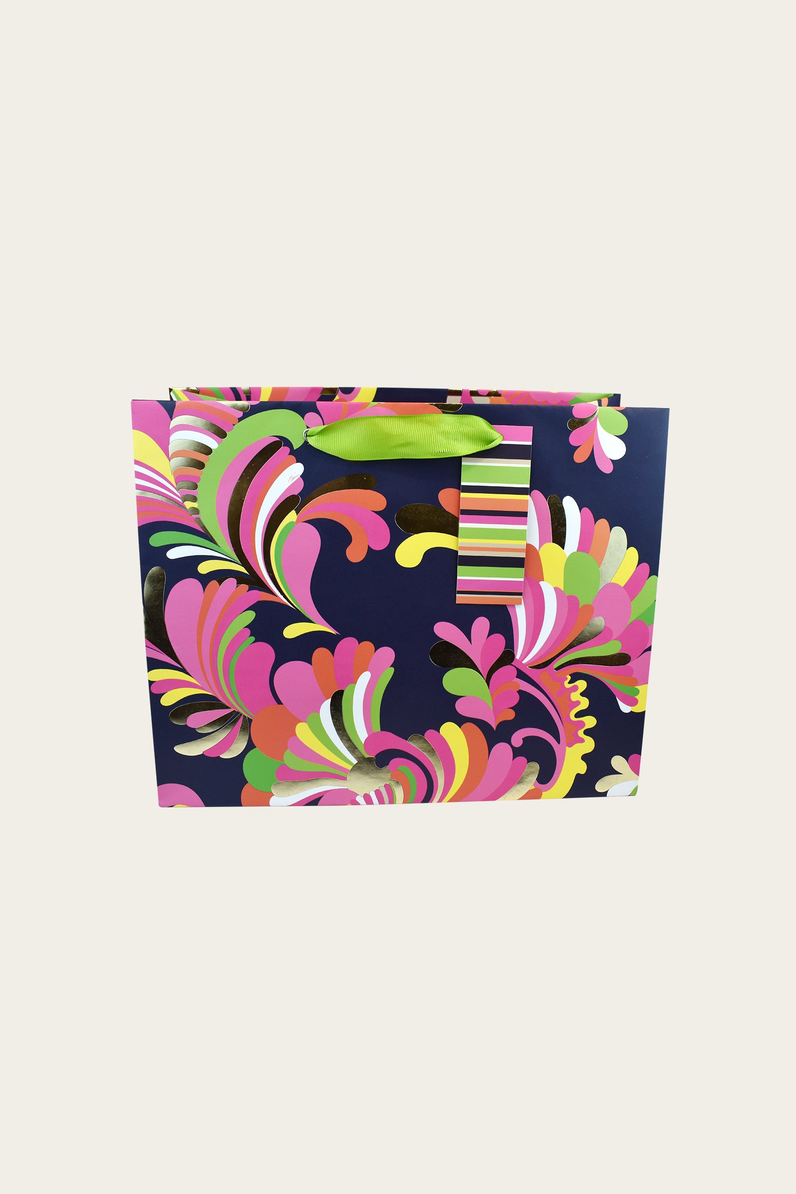 The TT Large Gift Bag - Palms Paradise features vibrant multi-colored floral patterns on a dark blue background and includes a green ribbon handle—perfect for colorful gifting.