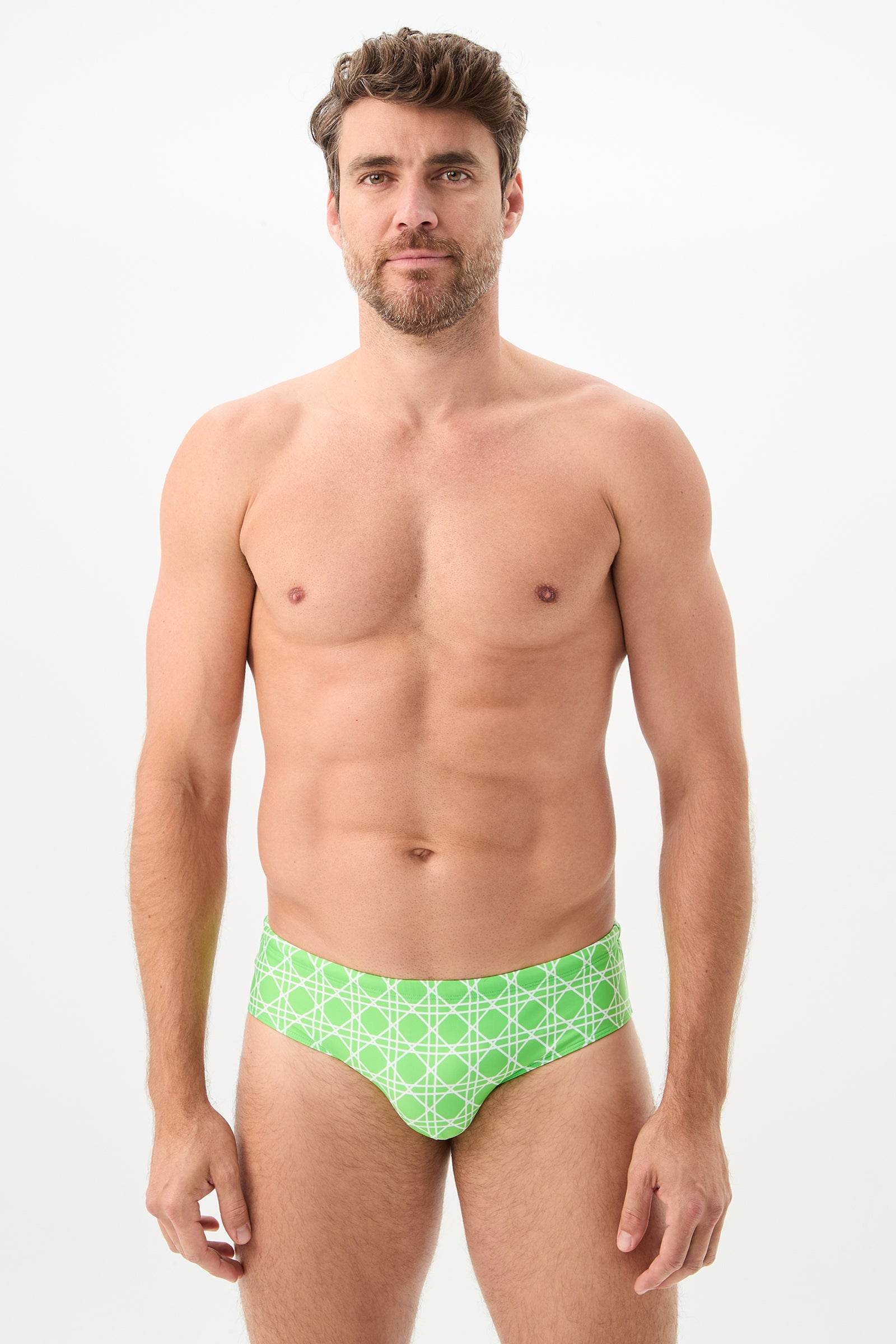 A man with short brown hair and a beard stands facing forward, wearing the Bondi Swim Brief in Billie Jean against a plain white background.