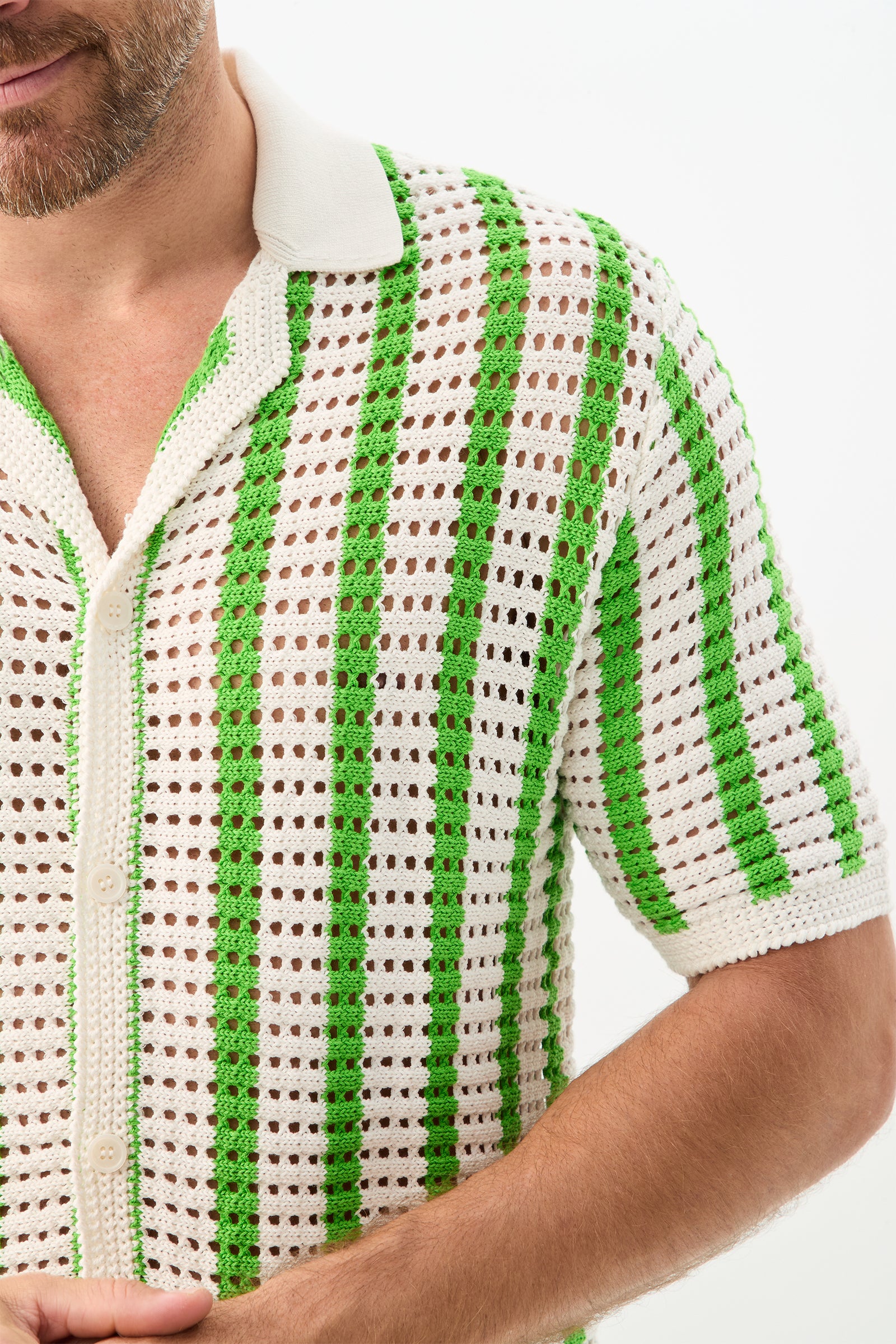 A person wears the Easton 2 Short-Sleeve Shirt, featuring white crochet fabric with vertical green stripes and a white collar, shown from shoulders to waist against a plain background.