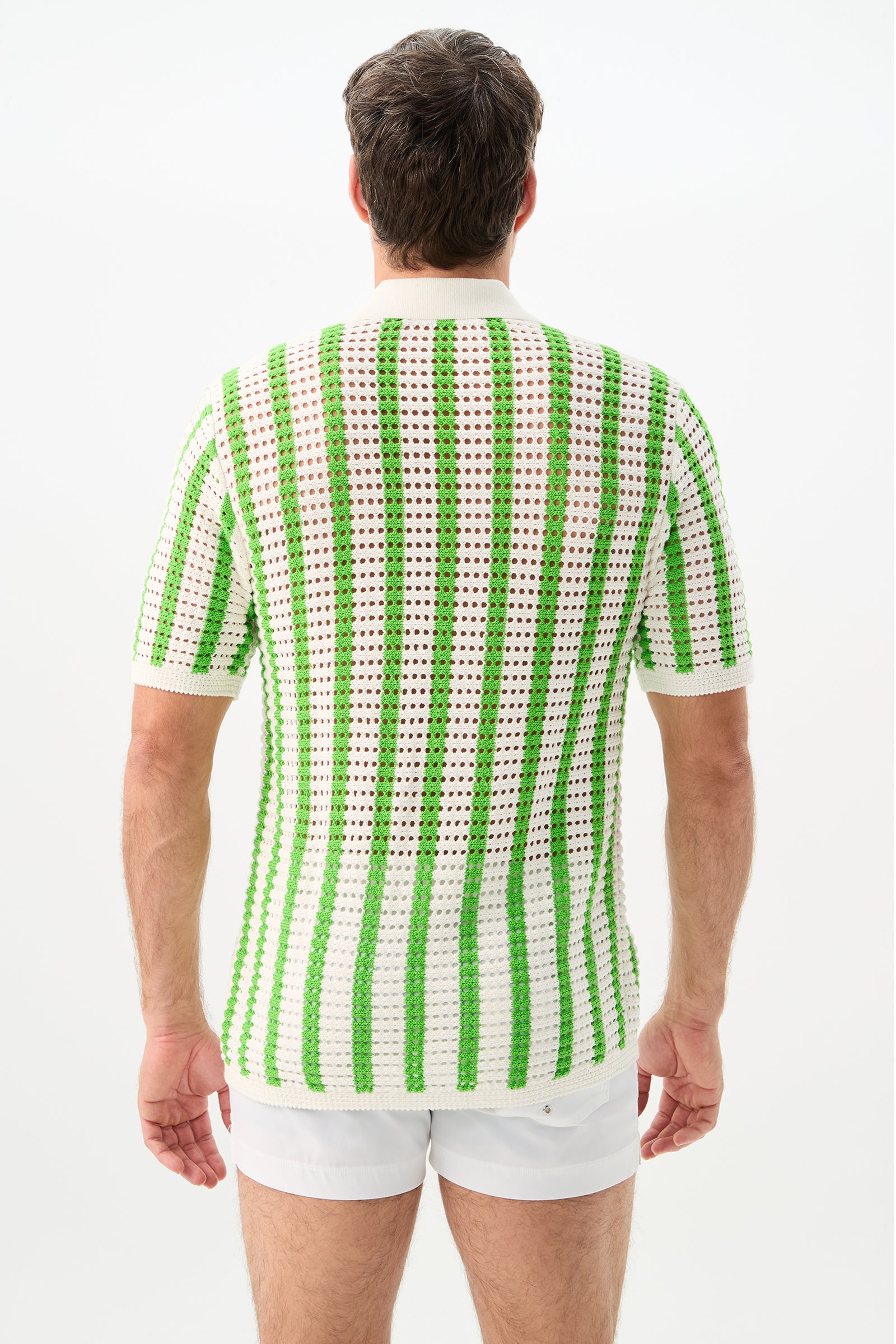 A person with short brown hair, seen from behind, wears the green and white striped Easton 2 Short-Sleeve Shirt and white shorts against a plain white background.