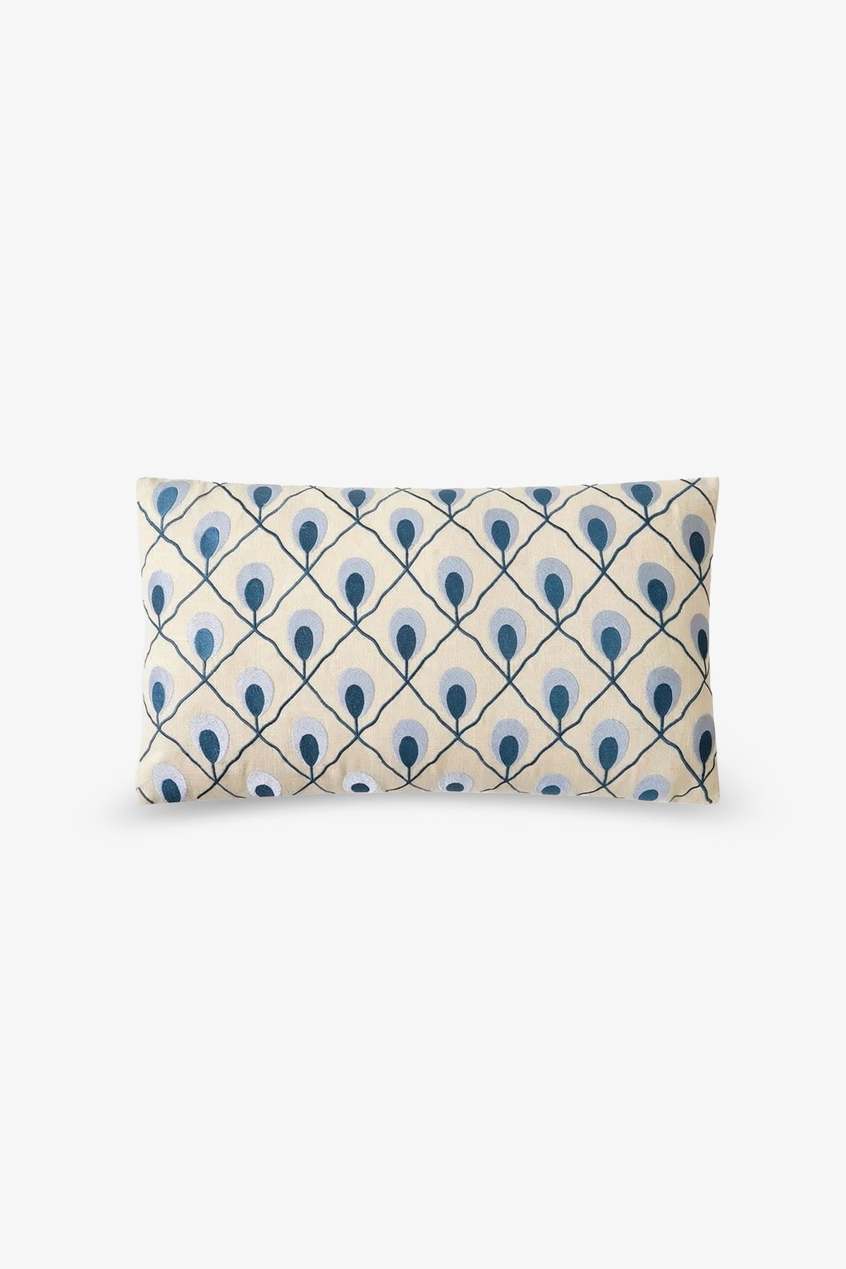 Roseville Embroidered Lumbar Pillow featuring a cream background and a repeating pattern of blue dots and lines forming a diamond lattice design reminiscent of stylized peacock feathers.