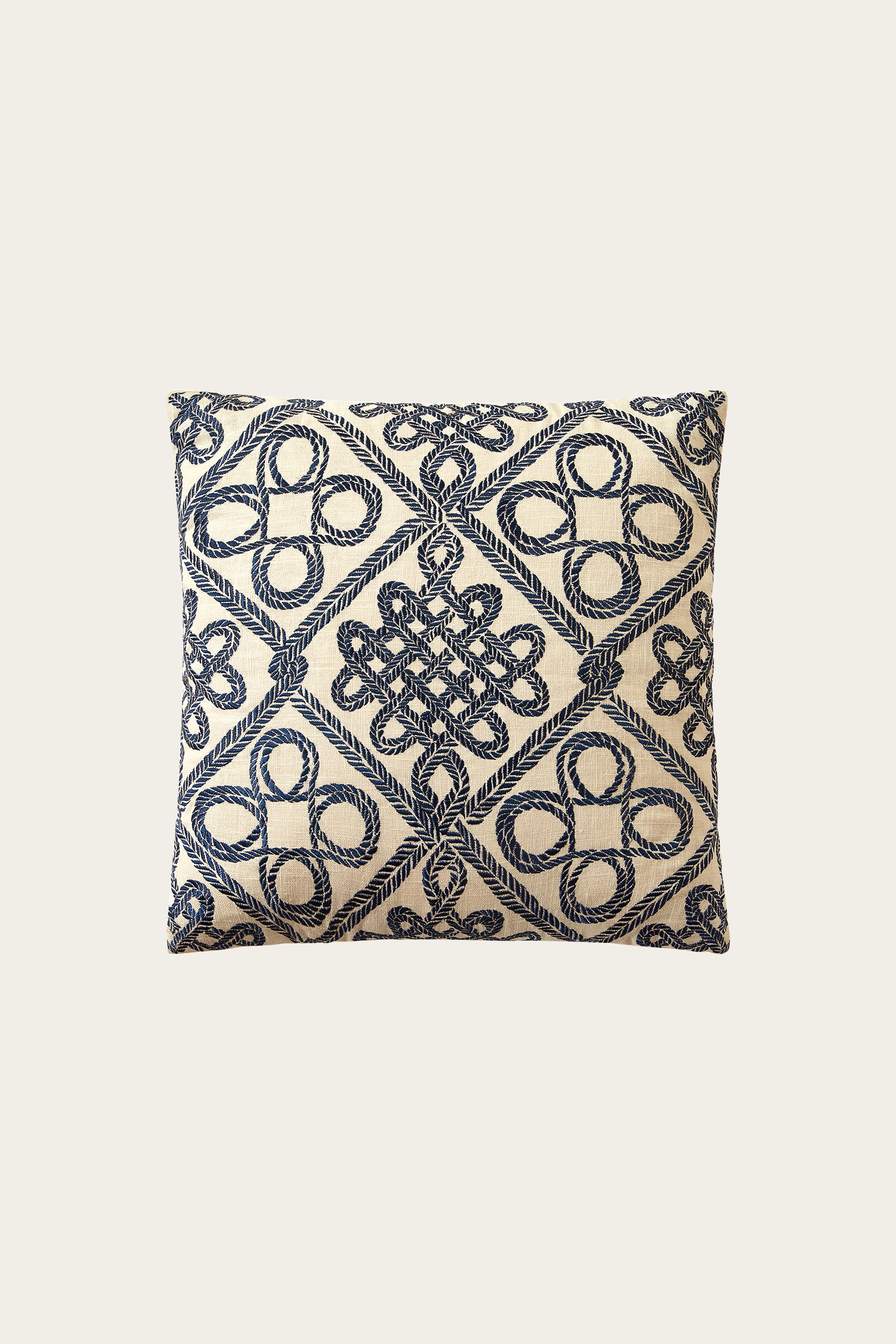 The Costa Mesa Embroidered Euro Throw Pillow - Blue features a cream background with blue geometric embroidery of loops and diamonds, shown against an off-white backdrop.