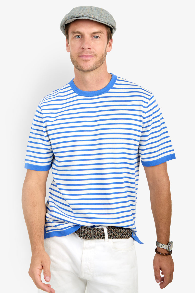 A man in a gray flat cap, white pants, braided belt, watch, and the Giovanni Stripe Short-Sleeve Pullover stands against a plain white background, looking at the camera.