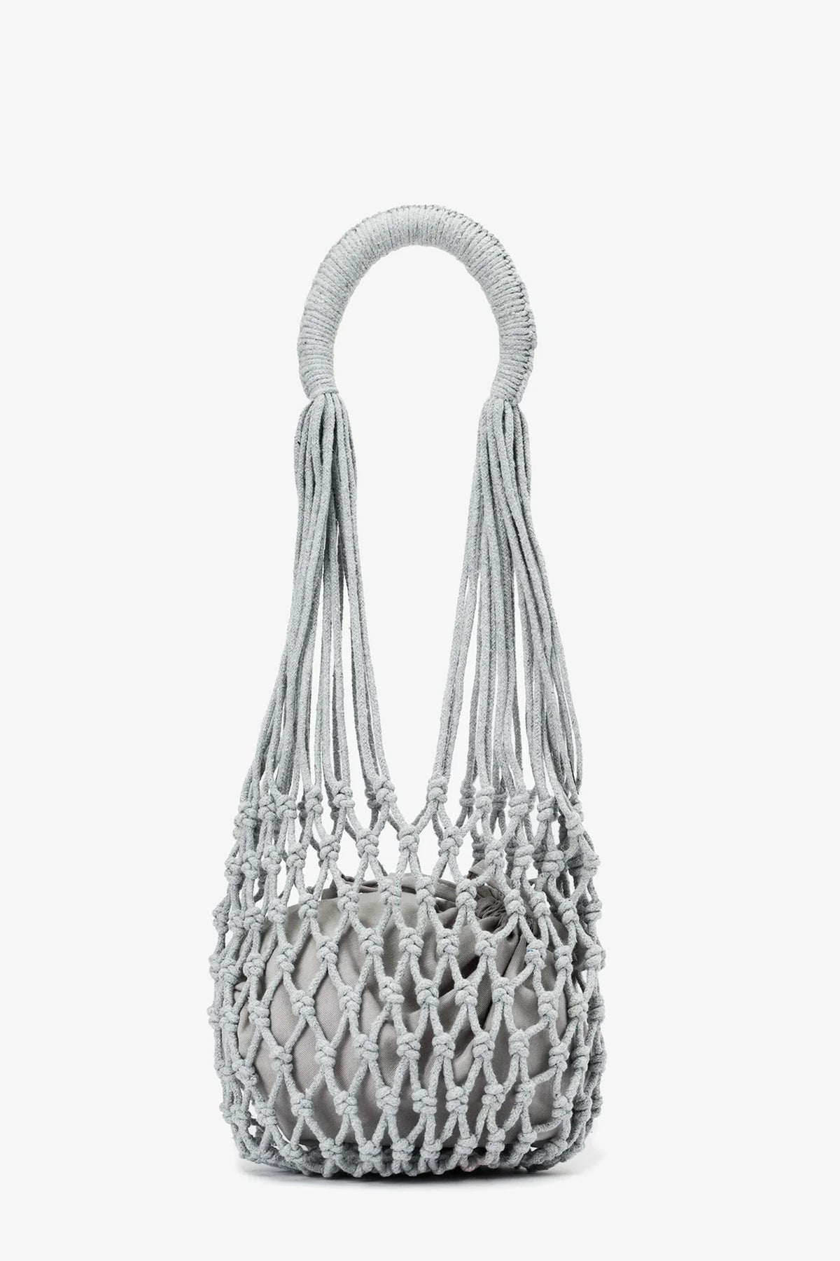 Introducing the Nannacay Kim Woven Bag—a light gray, knotted rope handbag featuring a circular handle and an open, net-like design with a compact inner pouch.