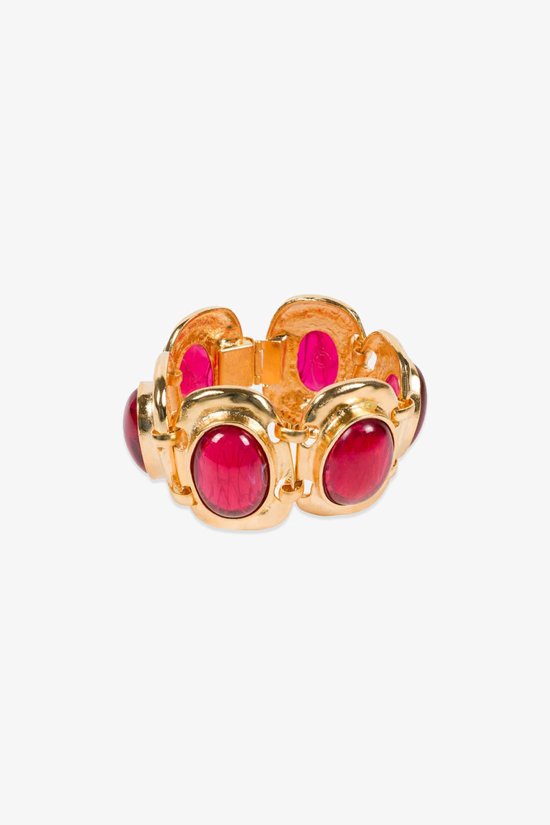 A Ruby Cabachon Bracelet featuring large oval red stones set in rounded bezels, linked together in a bold, vintage-inspired design on a white background.