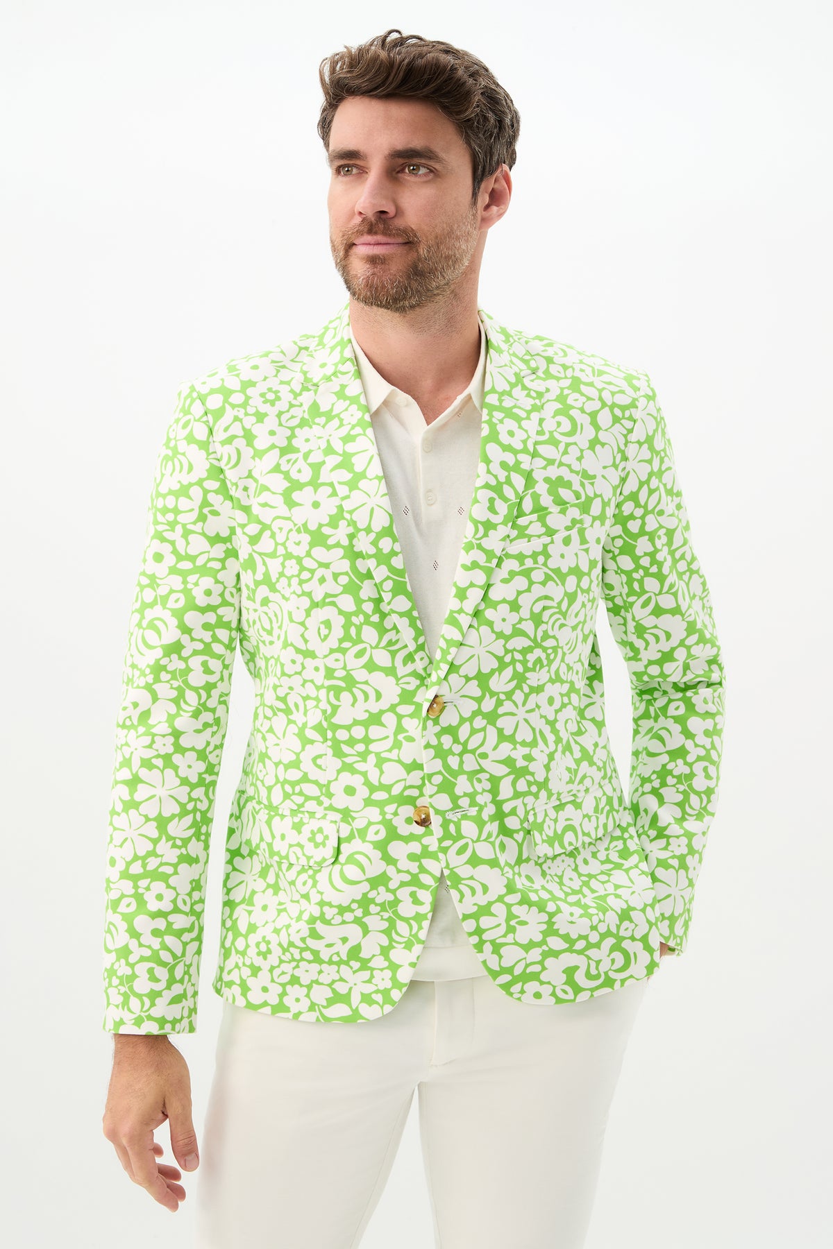 Man wearing the Thurston Blazer - Poolside Gossip in Serene Green over a white shirt and pants, standing against a plain white background, looking slightly to the side with a relaxed expression.