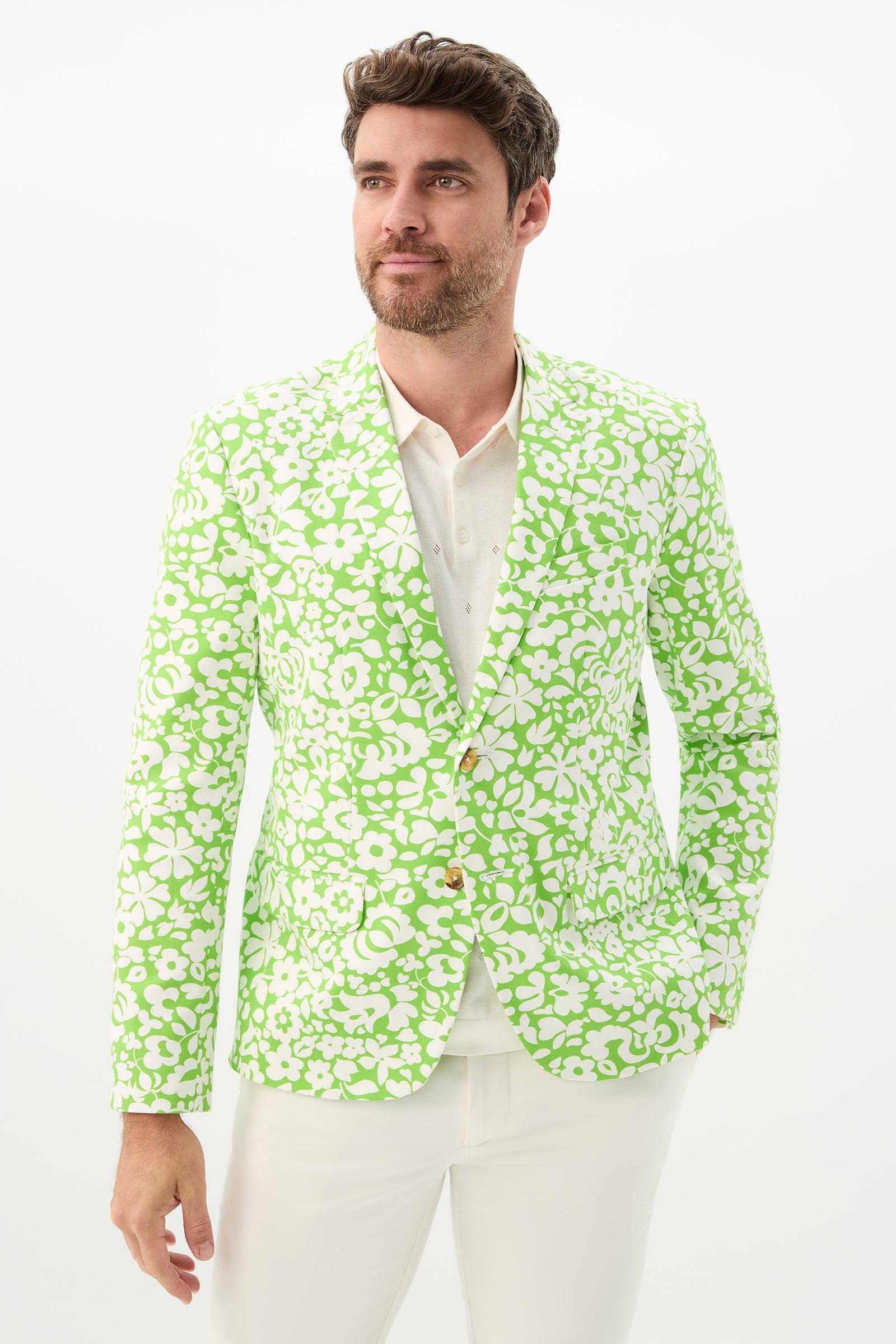 Man wearing the Thurston Blazer - Poolside Gossip in Serene Green over a white shirt and pants, standing against a plain white background, looking slightly to the side with a relaxed expression.