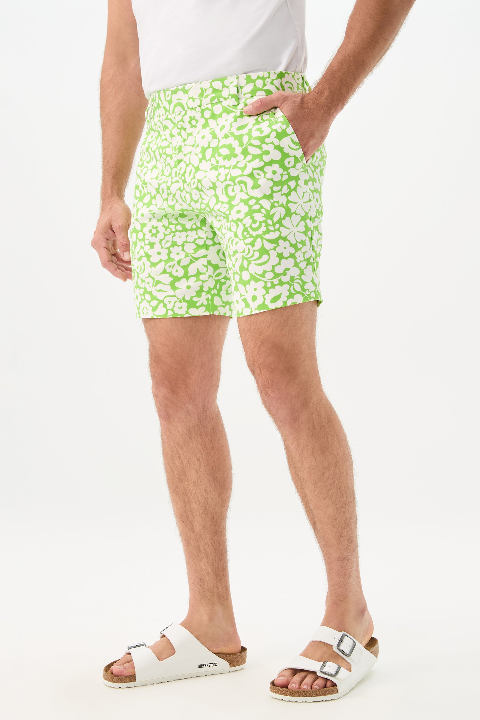 Wearing the Lawrence Short - Poolside Gossip, a white t-shirt, and white Birkenstock sandals, a person stands with one hand in their pocket against a plain background.