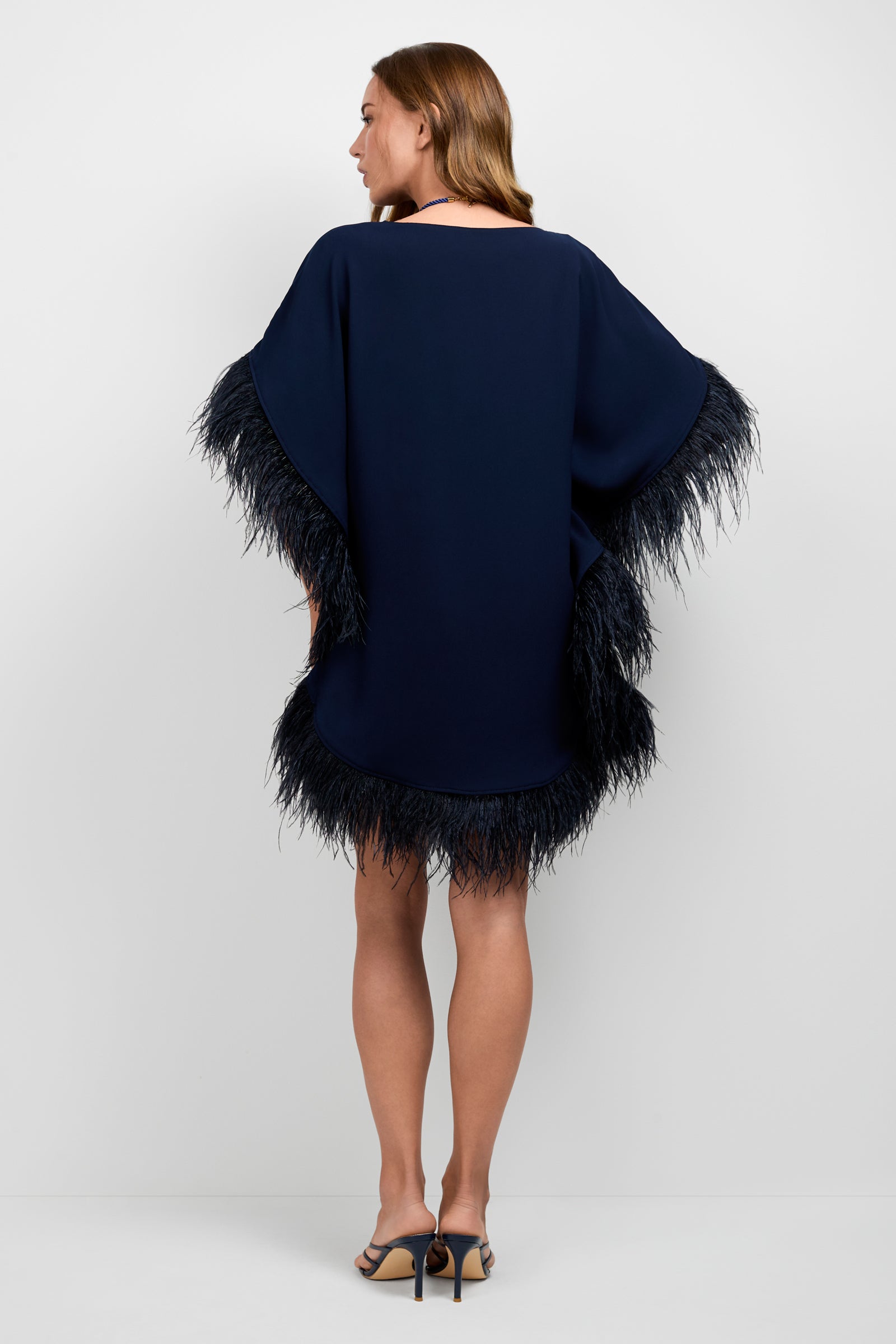 A woman wearing the Mini Neena Caftan Dress.