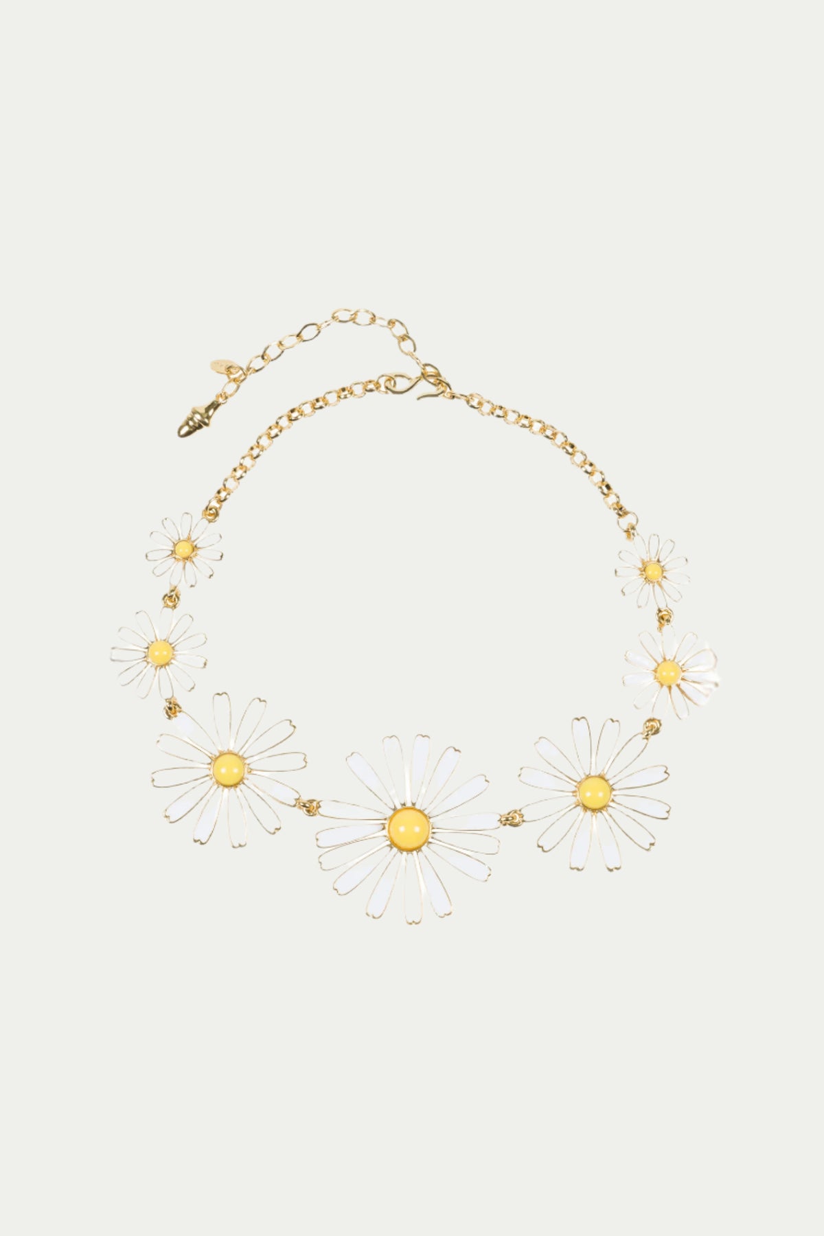 The TT x KJL Daisy Enamel Collar Necklace in white features transparent daisy-shaped charms with yellow centers arranged around the front and an adjustable clasp with extension chain.