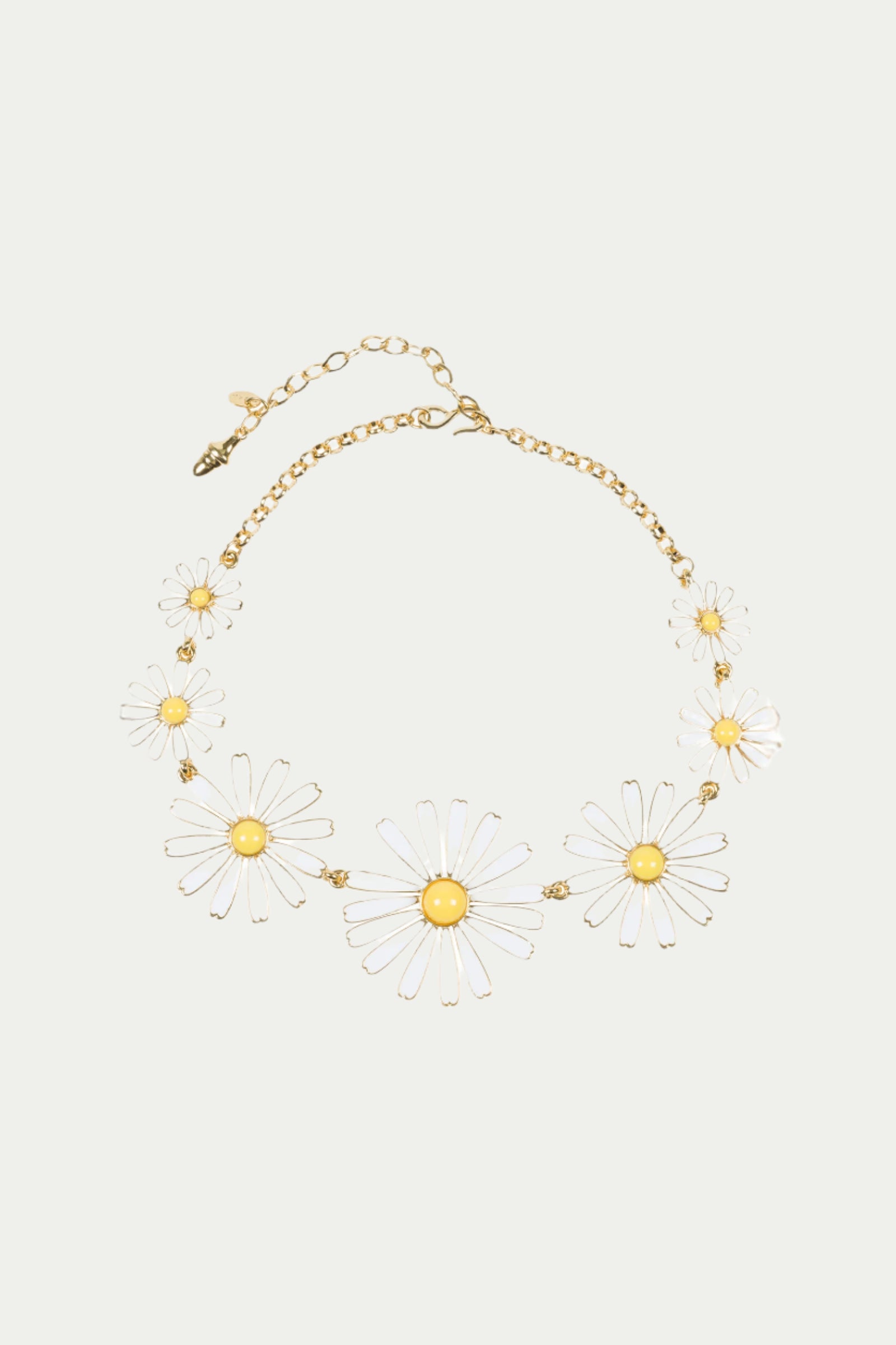 The TT x KJL Daisy Enamel Collar Necklace in white features transparent daisy-shaped charms with yellow centers arranged around the front and an adjustable clasp with extension chain.