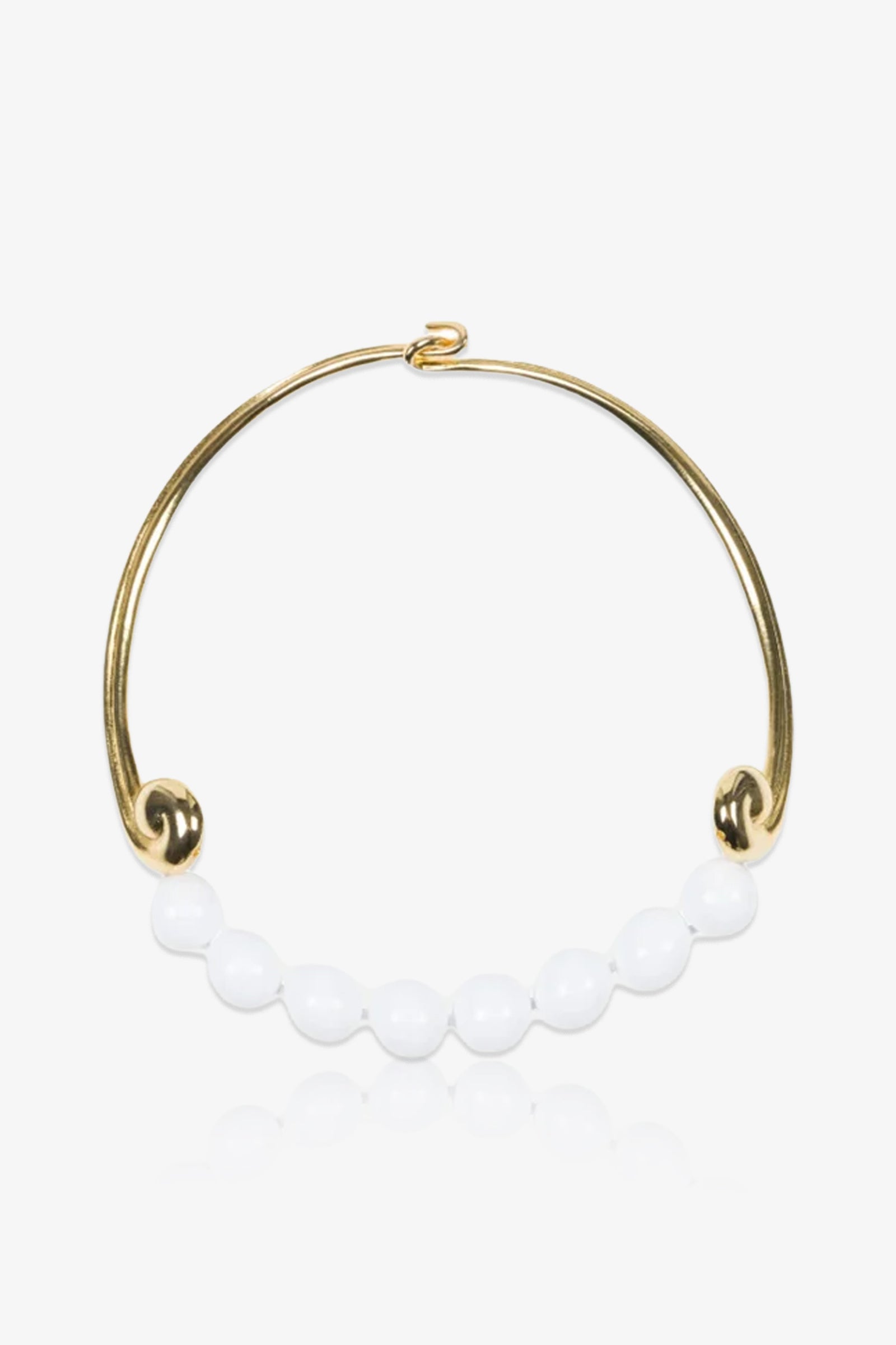 The KJL Beaded White and Gold Collar Necklace features a row of round white beads along its graceful gold curve, finished with decorative loops at each end.