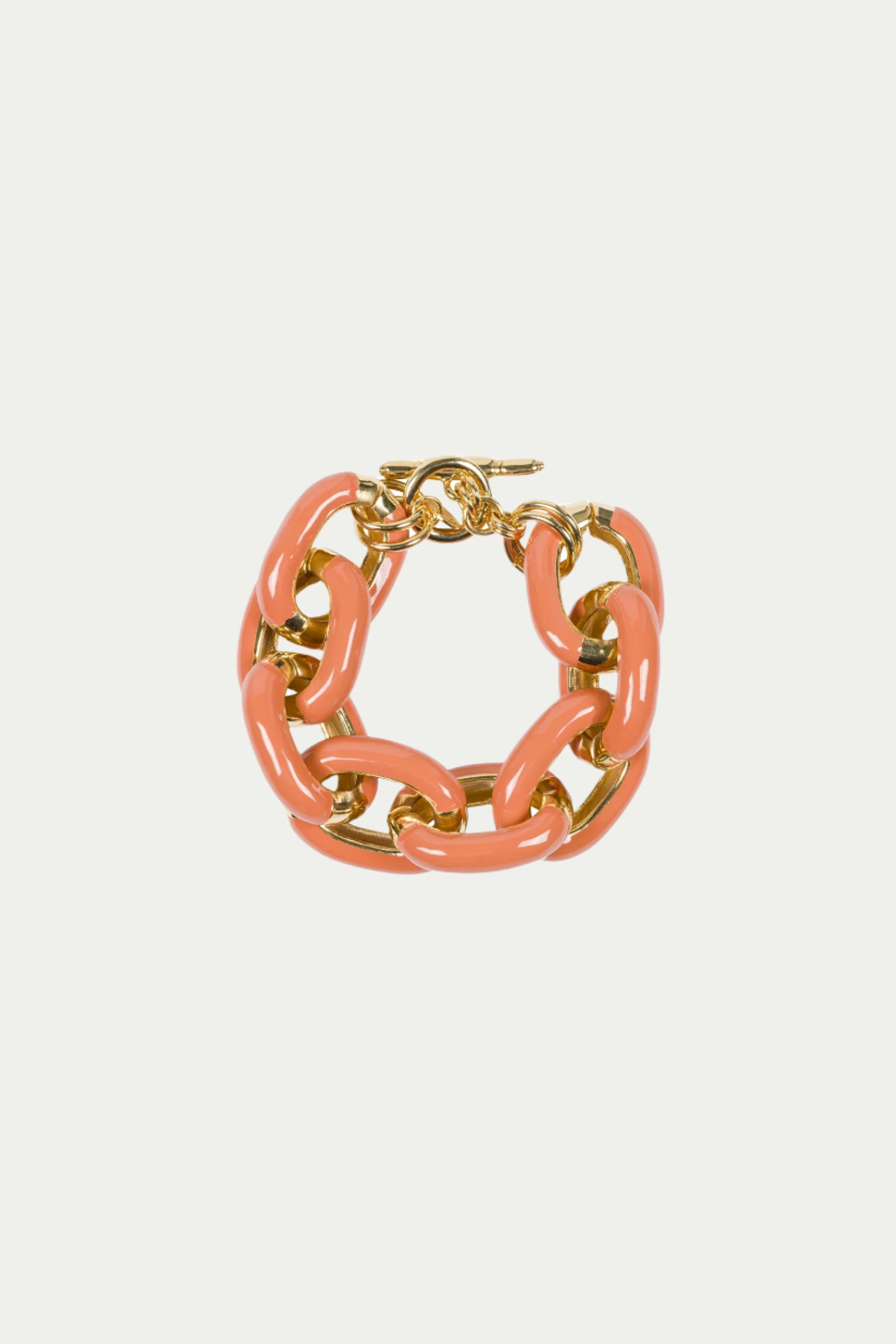 The TT x KJL Enamel Link Bracelet in Coral showcases large, glossy coral links mixed with shiny gold accents, displayed on a plain white background.