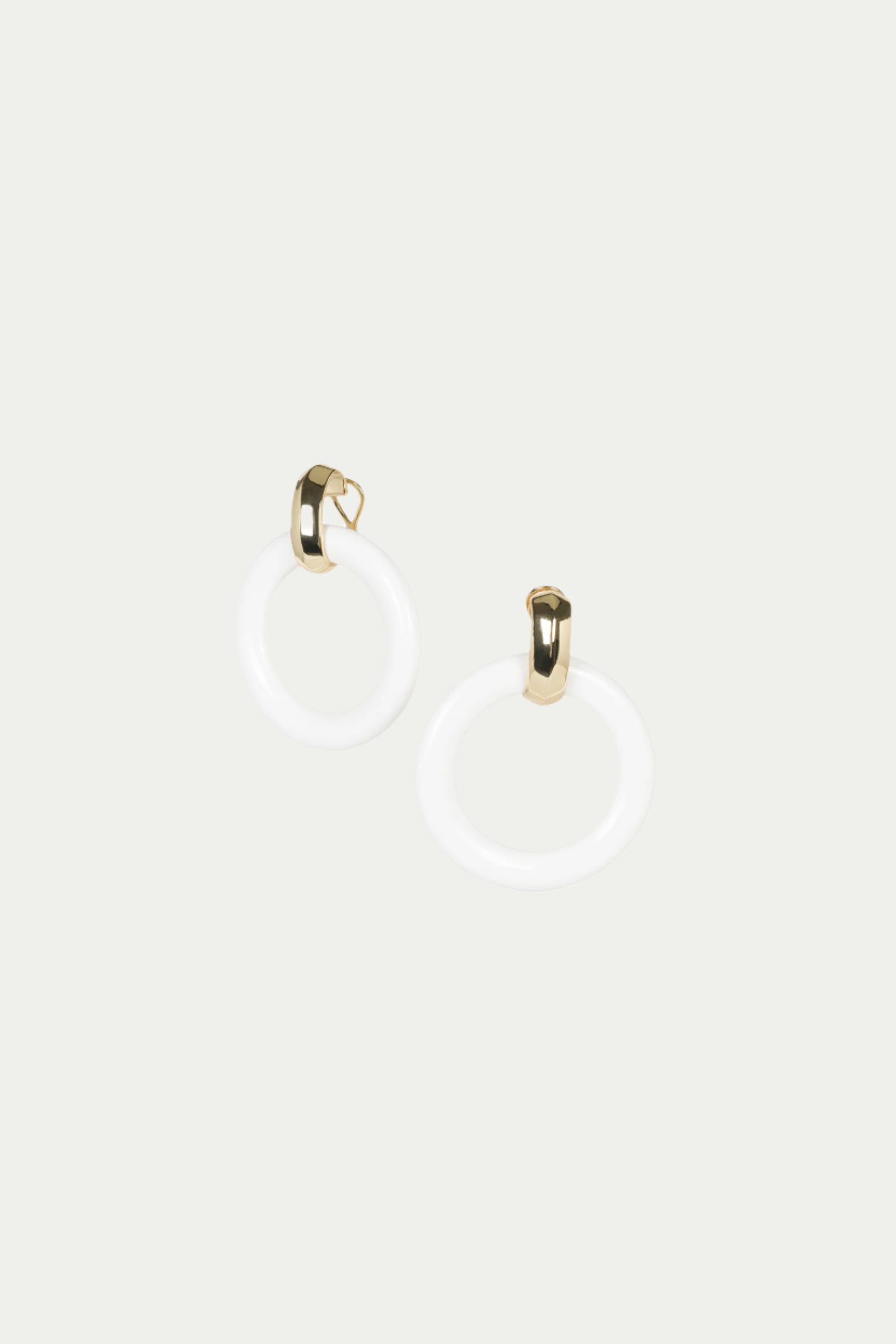 TT x KJL Doorknocker Earrings in white feature modern circular hoops with gold-toned clasps, shown against a plain light background.