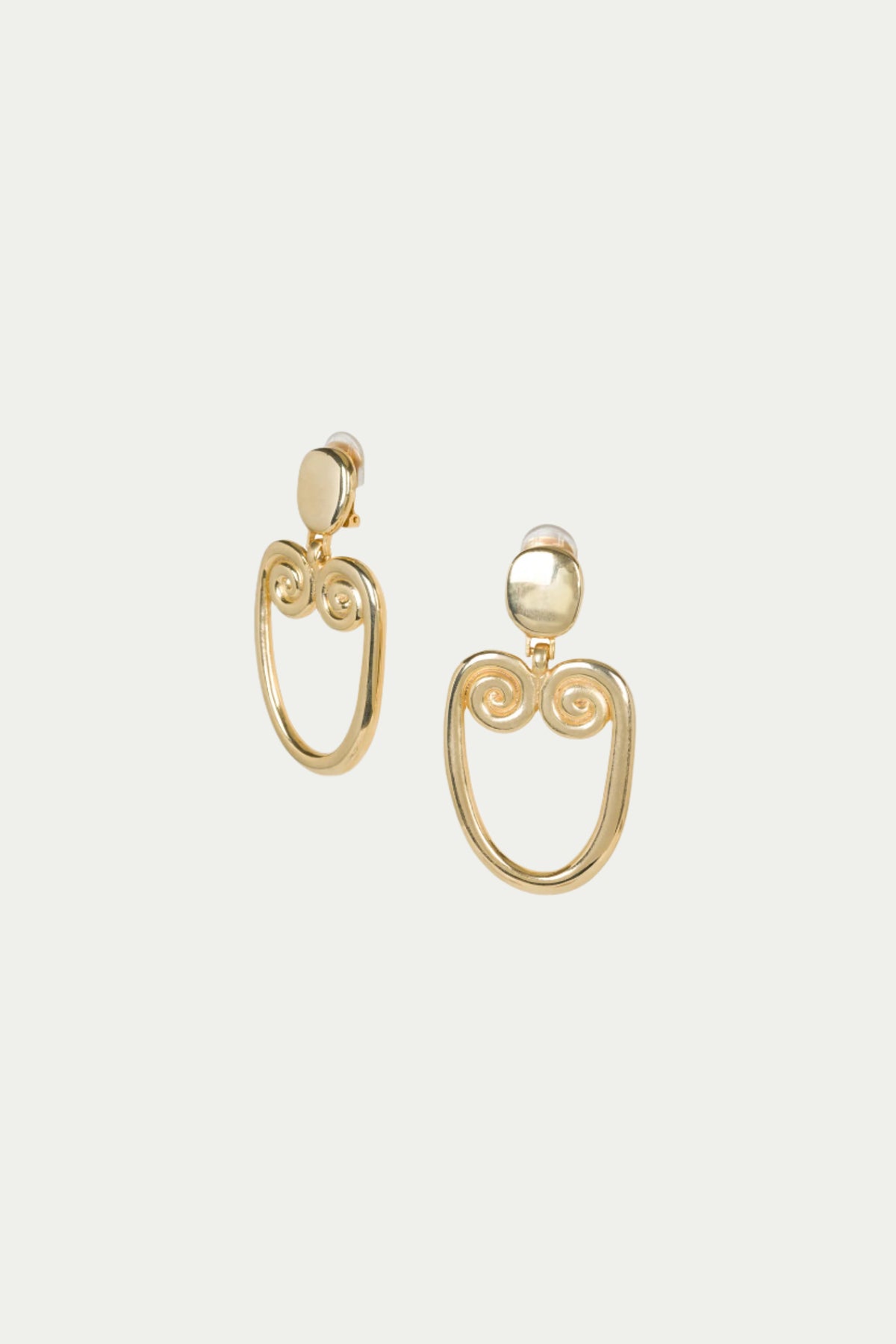 TT x KJL Gold Double Scroll Clip-On Earrings feature gold round studs with open, oval-shaped dangles and decorative spiral details at the top.